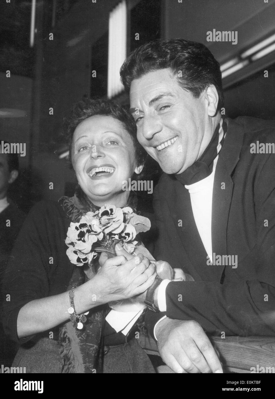 Jacques Pills gives wife singer Edith Piaf flowers Stock Photo