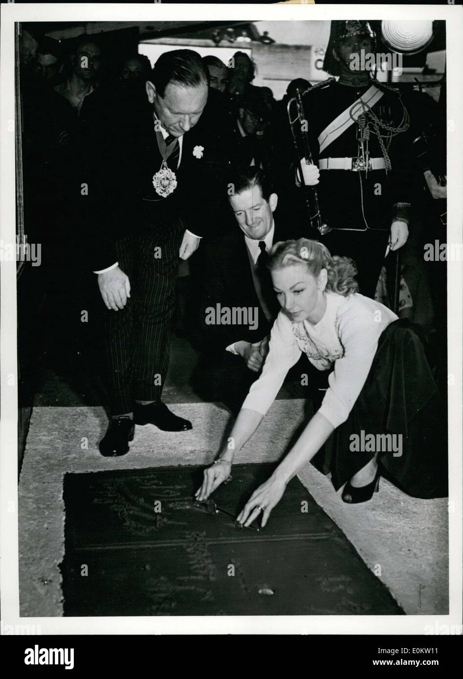 Jun. 30, 1951 - Film actress and star of the ''London Melody'' Belita signs her name on a wet cement plate in Empress Hall in London. Stock Photo