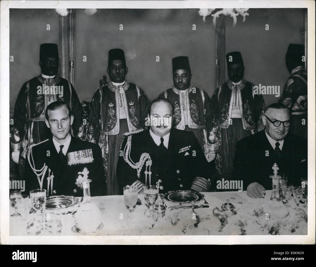 Jan. 31, 1950 - King Farouk with Duke of Edinburgh and Ernest Bevin.: In front of vie servants in Arabian Night's costume sat the Duke of Edinburgh, king Farouk (Center) and Mr, Bevin( right) the British Foreign Minister. The luncheon, given by King Farouk,was held in Koubba Palace. Before the luncheon, Mr. Bevin, homeward bound form the  Conference of Foreign Ministers, discussed the International situation with Egypt. Stock Photo