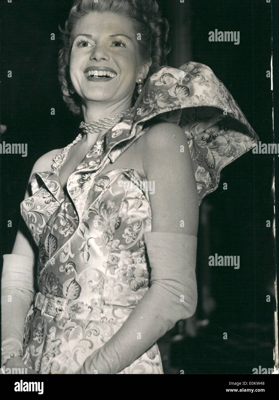 Mar. 03, 1950 - Zoe Gail's One-Shouldered Dress: Actress Zoe Gail wearing a one-shouldered dress in multi-patterned satin. The bodies is boned and strapless with a cuff-tap, and the one-shouldered effect is given by the wide frilled strip of material worm over the left shoulder and stiffened out like and outsize epaulette - Photo shows was taken during the XXVI Club's dinner, hold last night at the 21 Club in London. Stock Photo