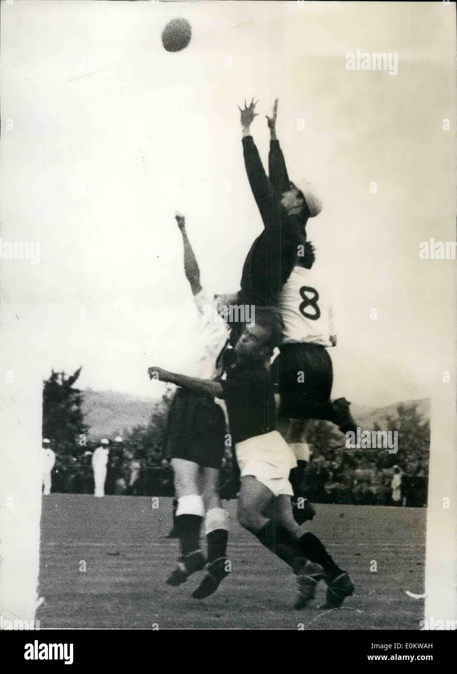 May 05, 1950 - England beat Portugal by five goals to three in Lisbon: Photo shows England score their second goal. The Portuguese goalkeeper jumps in a vain attempt to save England's second goal hard pressed by Tom Finney (left) and Mortensen (no.8) Stock Photo
