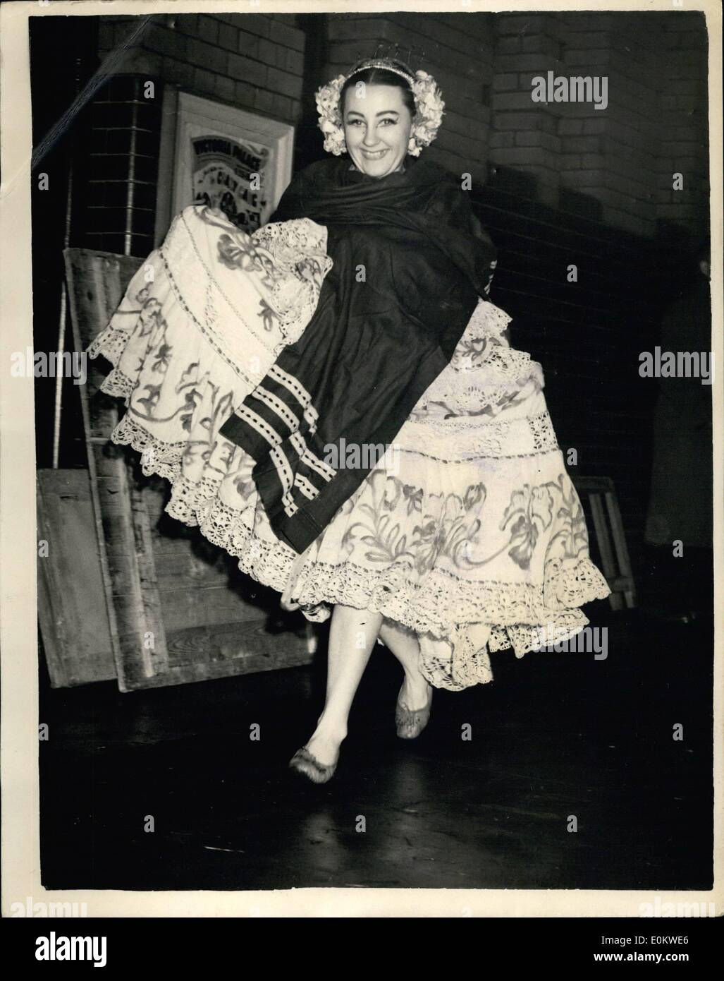 Oct. 10, 1951 - Artists in the royal Variety performance arrive by coaches at the Victoria Palane. Owing to the lack of dressing room accommodation at the Victoria Palace some of the artists had to use dressing rooms at near by theaters. Three motor coaches maintained a shutter service to carry them in their stage dress between the theaters. Photo shows One of the Latin-American appearing in the command performance hurries to the stage door of the Victoria palace after being brought there by one of the motor coaches. Stock Photo