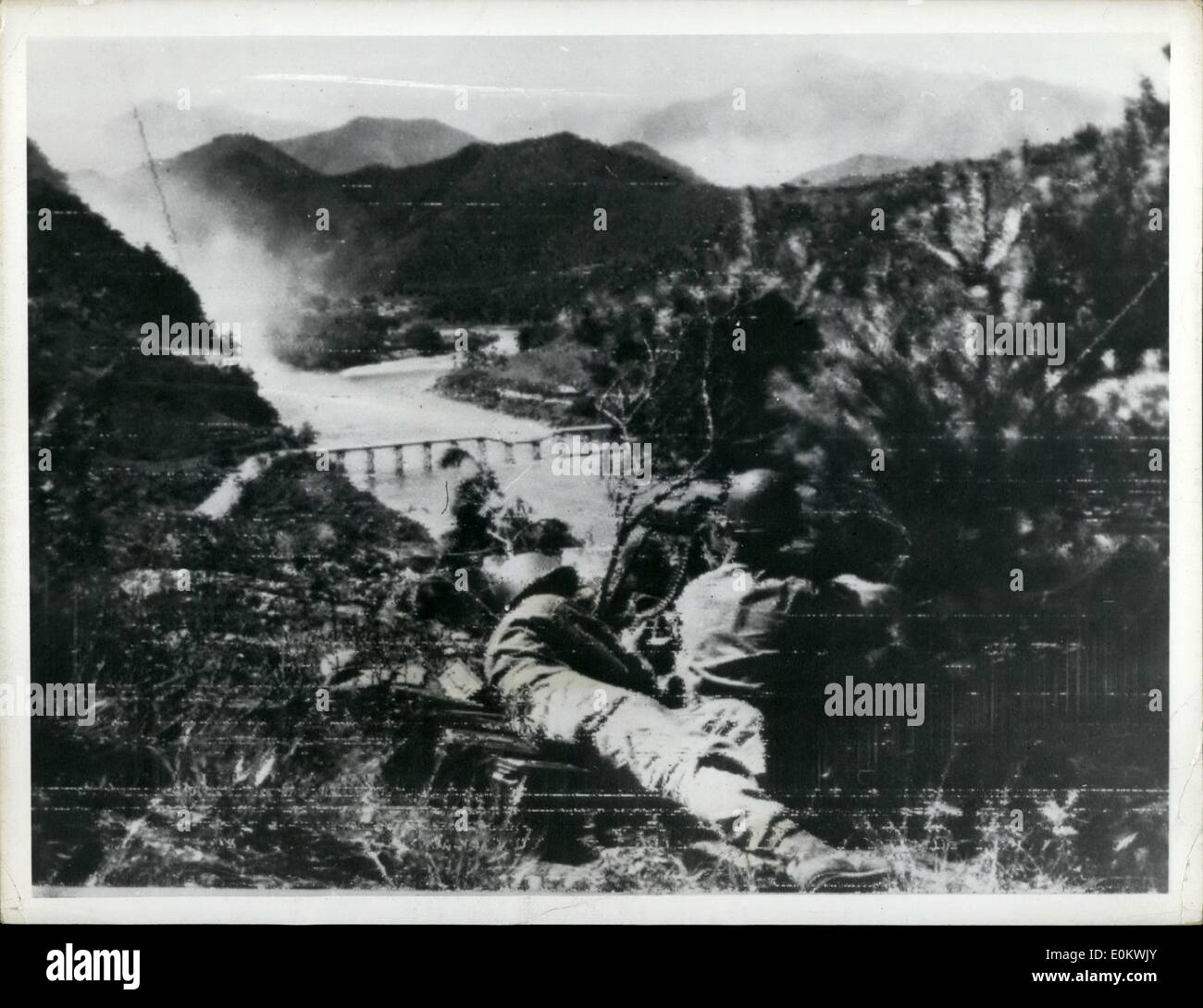Jul. 07, 1950 - Doing some bridgework : Korea Two American infantrymen rest their machine gun on an emplacement overclocking a bridge, half destroyed and fire at the opposite ridge, about 2 miles north of Chingog. Ni.Yusong position over looking the kap-chion river and the main hishuray. Stock Photo