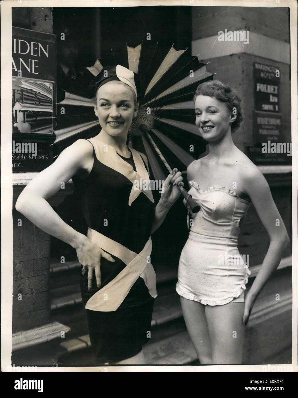 Apr. 04, 1952 - Contrast in Sports Styles. 1952 wSim Suit And the 1927 model.: Many new styles were to be seen - contrasted with their old-time equivalents - in the Teddy Tinling - M.G.M. dress Show-held at Rule's Maiden Lane, this afternoon. Photo shows Jill Howard wears an Ivory satin Lastex brocade swimsuit, with a strapless boned bra top and frilled apron skirt - while Elizabeth Chantler wears it 1927 equivalent at the show this afternoon. Stock Photo