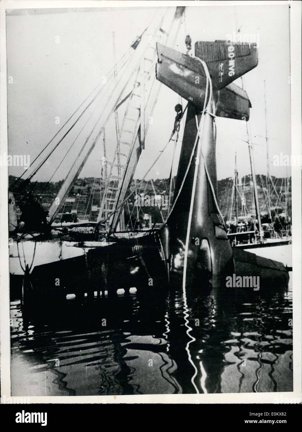 Apr. 22, 1952 - A young Dutchman crashed his plane in the port of Juan-les-Pins, France. Luckily he wasn't harmed. It is seen here being lifted out of the water by a crane. Stock Photo