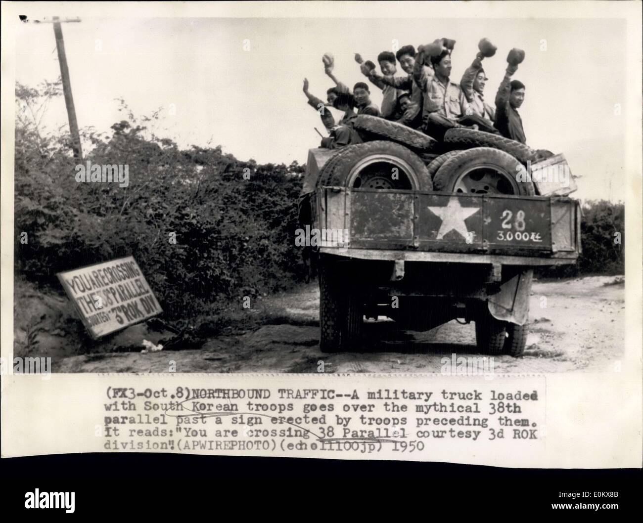 Oct. 08, 1950 - Northbound Traffic: A military truck loaded with South Korean troops goes over the mythical 38th parallel past a sign erected by troops presiding them. It reads: ''You are crossing 38 Parallel Courtesy 3d Rok Division. Stock Photo