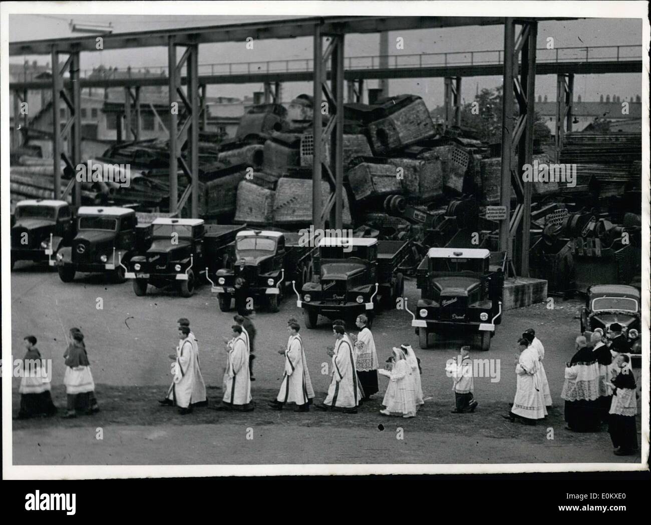 May 27, 1952 - Since the church in Obersendling bei Munich was too small to accommodate all the visitors that wanted to attend Priest Otto Vogel's first mass, they moved the sermon to this auto repair shop. Pictured here is the procession into the auto repair shop. Stock Photo