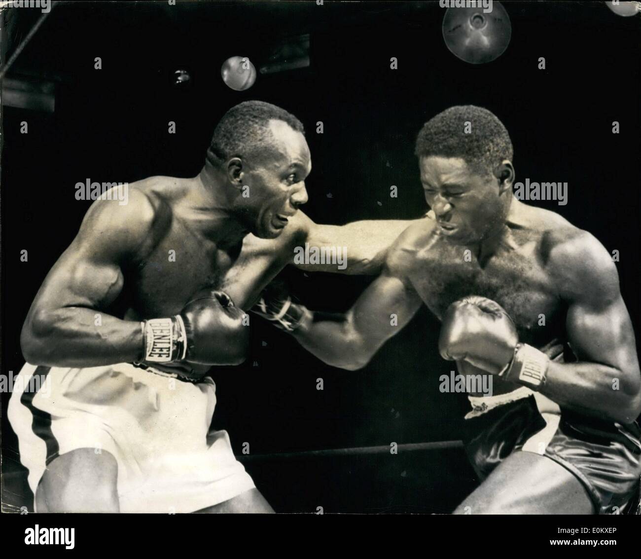 Jun. 06, 1952 - Jersey Joe Walcott retains his World Heavyweight title: Photo Shows Walcott misses with his left in the first round of his heavyweight title fight with Ezzard Charles, who scores with a hard right to the champion, but Walcott fought well to retain his title. When he best Charles over 15 rounds on points at Municipal Stadium, Pennsylvania. Stock Photo