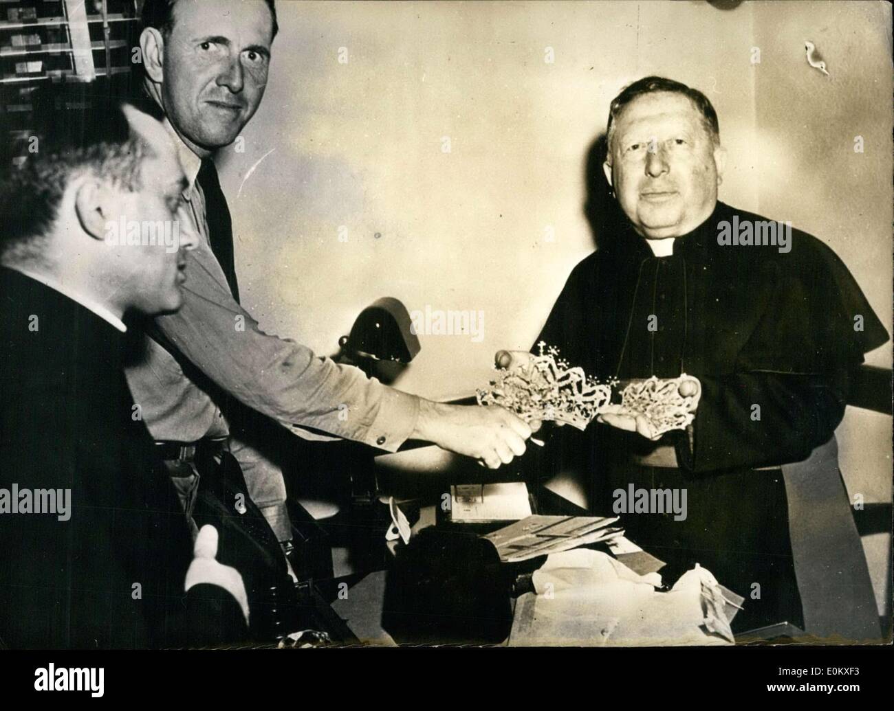 Jun. 14, 1952 - Pastor Angelo R. Cioffi(pictured right) was the leader of the ''Regina Pacie'' church in New York. The church itself had a shrine in which two crowns studded with diamonds and rubies were laid, valued at over 00,000. He had to follow his own sermon when the crowns ended up getting stolen. A week after the theft, though, a mysterious package showed up at the pastor's house. Inside the package were the stolen crowns. A 1 1/2 carat diamond and 19 small jewels were taken from the two crowns Stock Photo