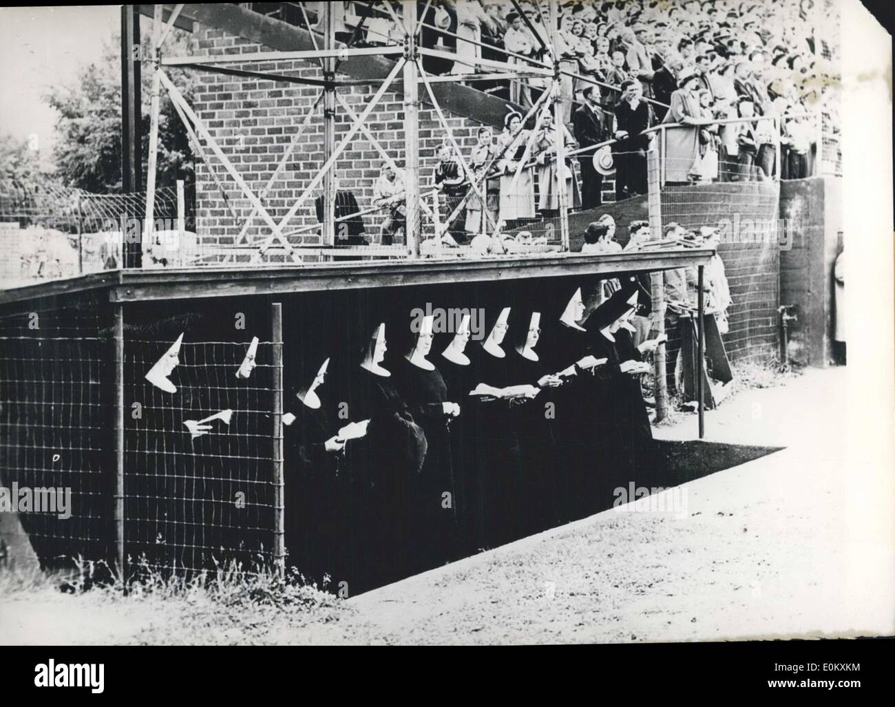 Jul. 02, 1952 - In Cold Spring, Minnesota you can find something that you won't see everyday: nuns in the dugout. These nuns are praying in their section while a raucous game of baseball takes place only a few feet away. Stock Photo
