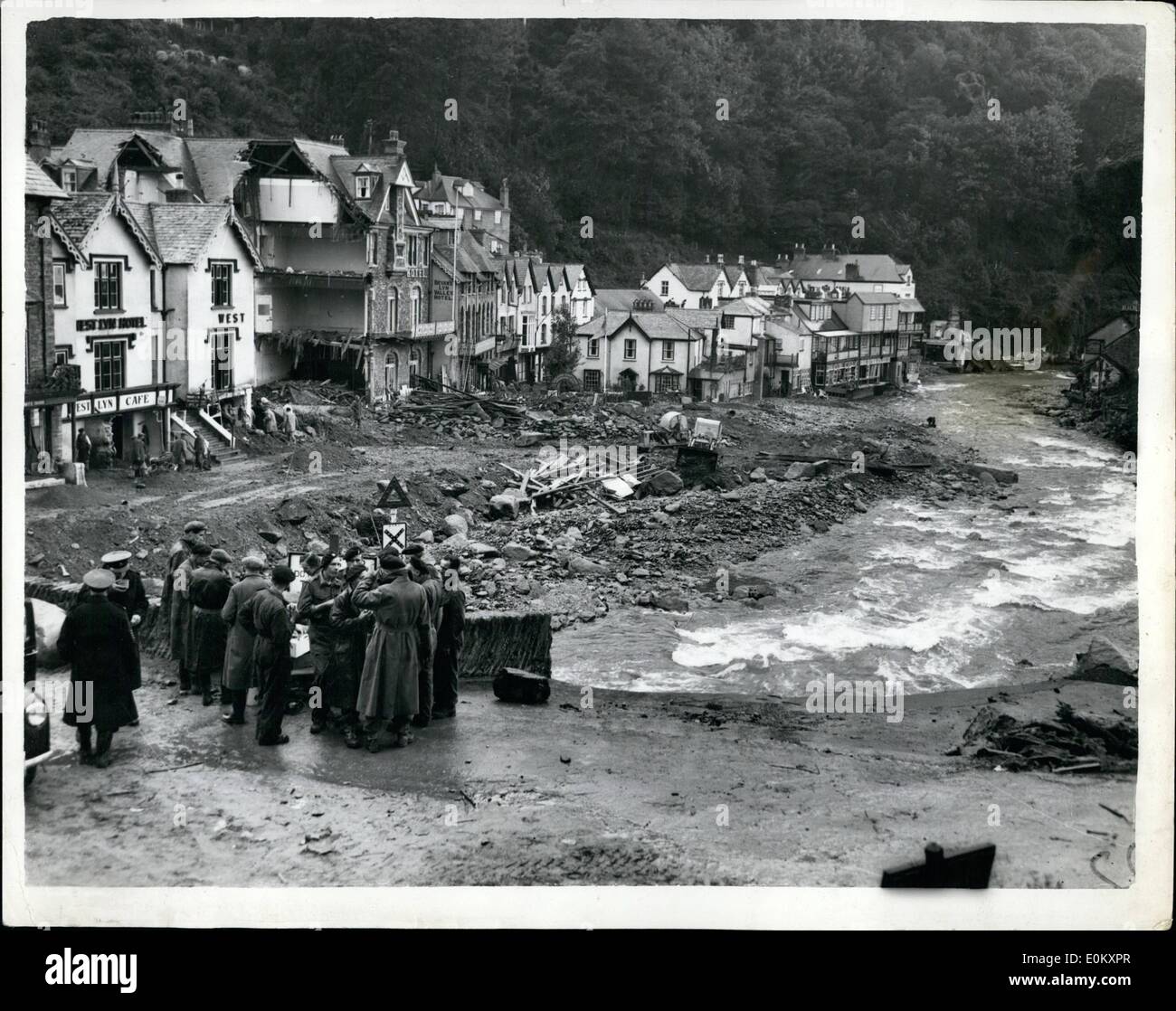 Aug. 08, 1952 - The Flood at Lynmouth. Photo shows Army personal take a welcome hot drink while standing on the wrecked bridge. Stock Photo