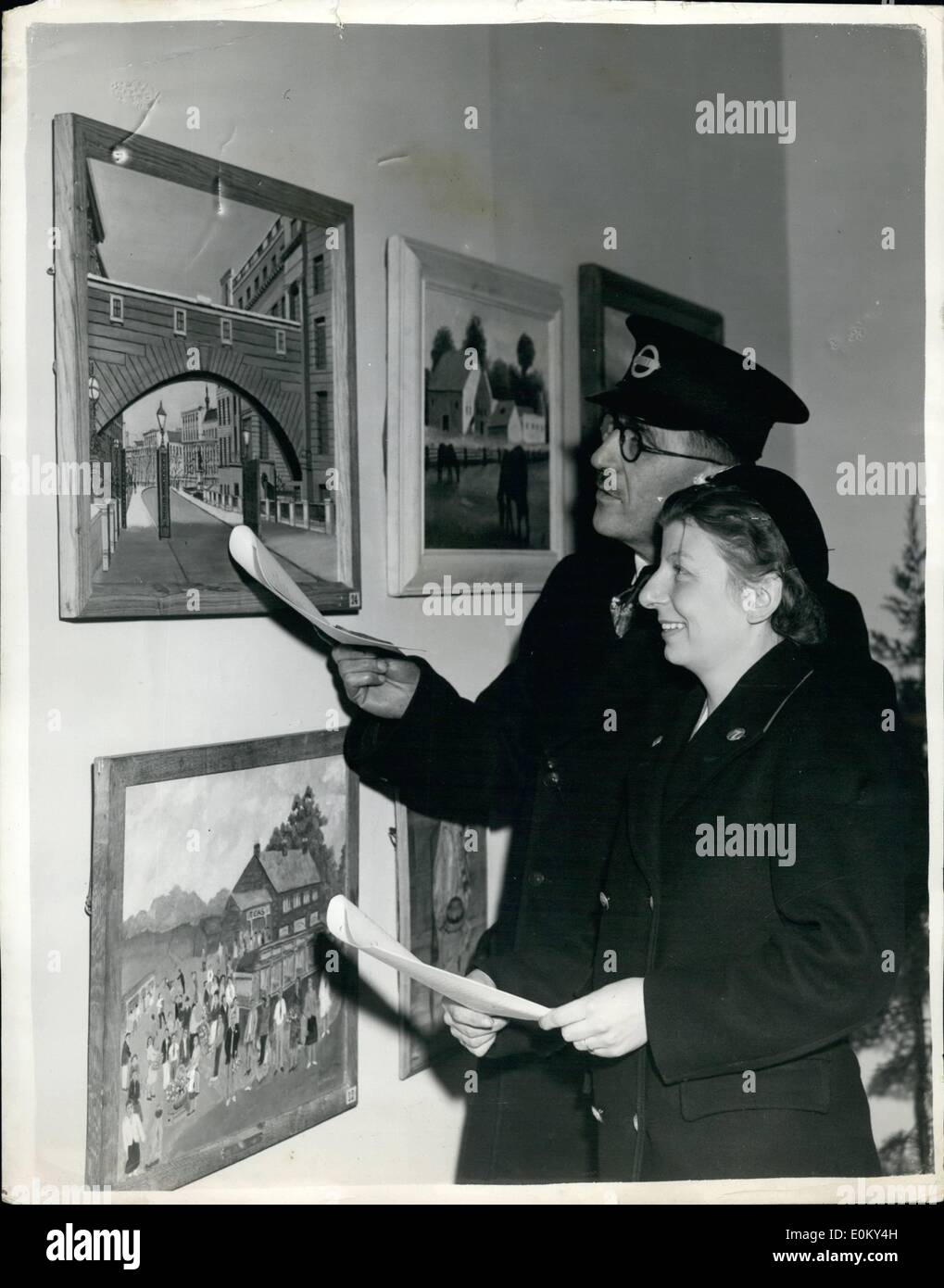 Nov. 11, 1952 - London Transport Art Exhibition. The Sixth Annual Exhibition of the London Transport Art Group, opened at Exhibition Hall, Charing Cross London Transport Station. Keystone Photo Shows:- Collector Sydney Fitter, of Hornchurch, and Joan Mitchell, a porter, of Battersea - looking at some of the exhibits. Stock Photo