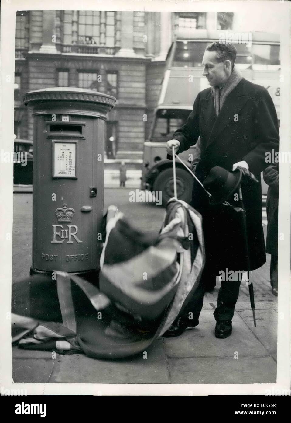 Nov. 11, 1952 - First G.P.O. Pillar Box With ''E.R.'' Cypher Unveiled In London.; The Earl Of Selkirk, O.B.E., Parliamentary Secretary to the Postmaster General - this afternoon unveiled the first G.P.O. pillar box which bears the new Royal Cypher ''E.R.'' on the Whitehell side of the Horse Guards Parade. Photo Shows The Earl Of Selkirk unveiling the new cypher on the pillar box today. Stock Photo