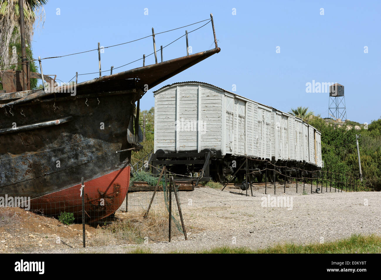 The photo from 08.04.2014 shows one issued refugee ships and three freight cars at the site of Atlit Immigrants Detention Camp (Ha'apola Museum) in Haifa/Israel. From 1939 to 1948 the Camp served as a detention center for illegal Jewish immigrants. Stock Photo