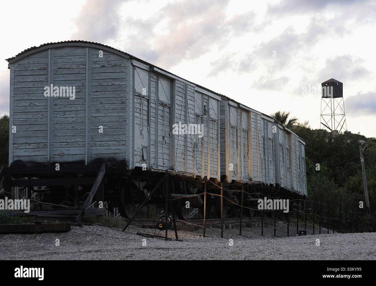 The photo from 09.04.2014 shows three freight cars and a watchtower at the site of Atlit Immigrants Detention Camp (Ha'apola Museum) in Haifa/Israel. From 1939 to 1948 the Camp served as a detention center for illegal Jewish immigrants. Stock Photo