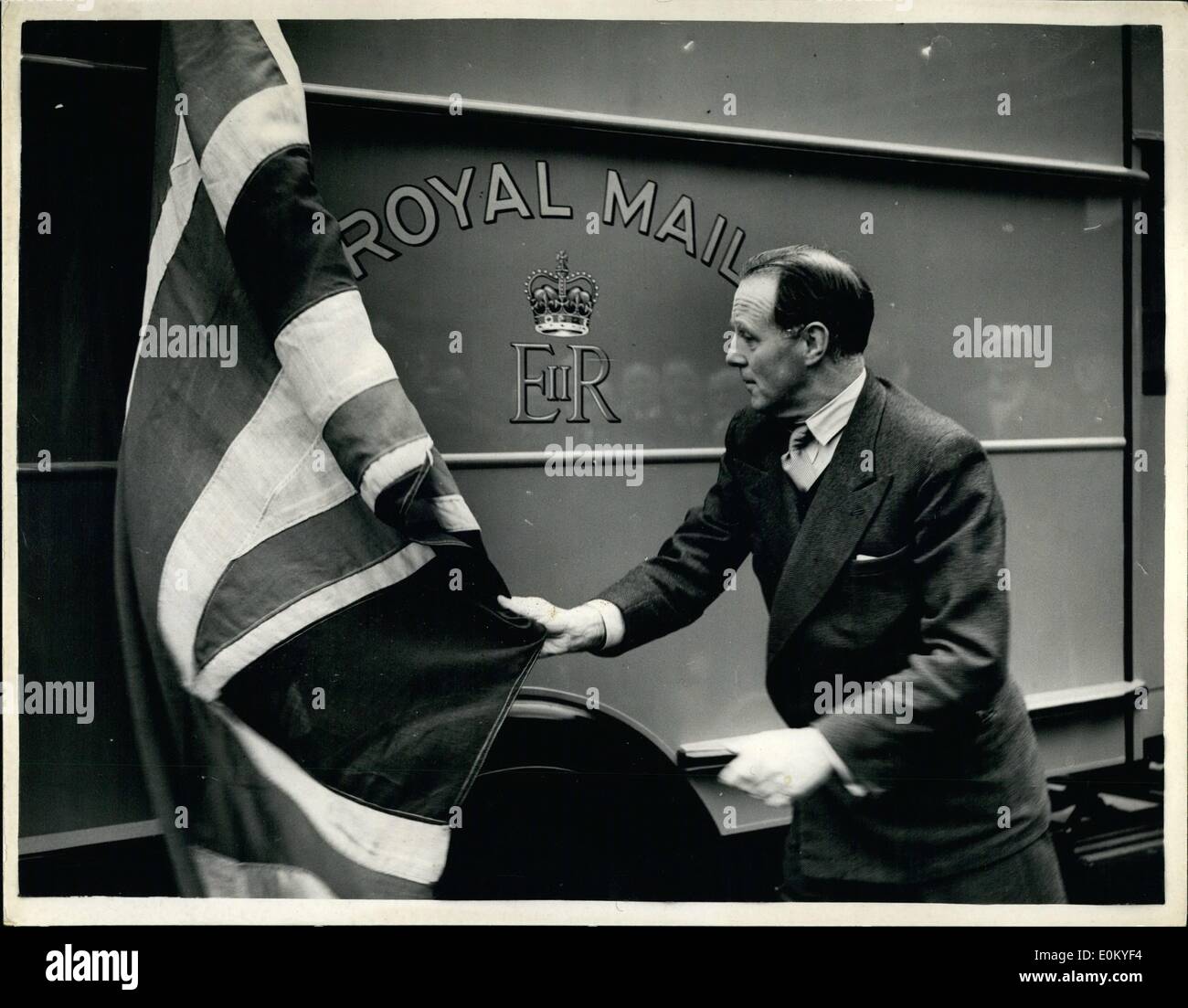 Nov. 11, 1952 - New Royal Cypher On Postal Van Unveiled By Postmaster General: The Postmaster General, Earl De La Warr, this morning unveiled the first postal van to bear the new Royal Cypher. There are about 2,200 motor mail vans in the London Area - and approximately 12,000 on the roads of the United Kingdom. In time all these vans will carry the new Cypher of Her Majesty. Photo shows Earl De La Warr seen unveiling the new Royal Cypher - in King Edward Building Yard today. Stock Photo