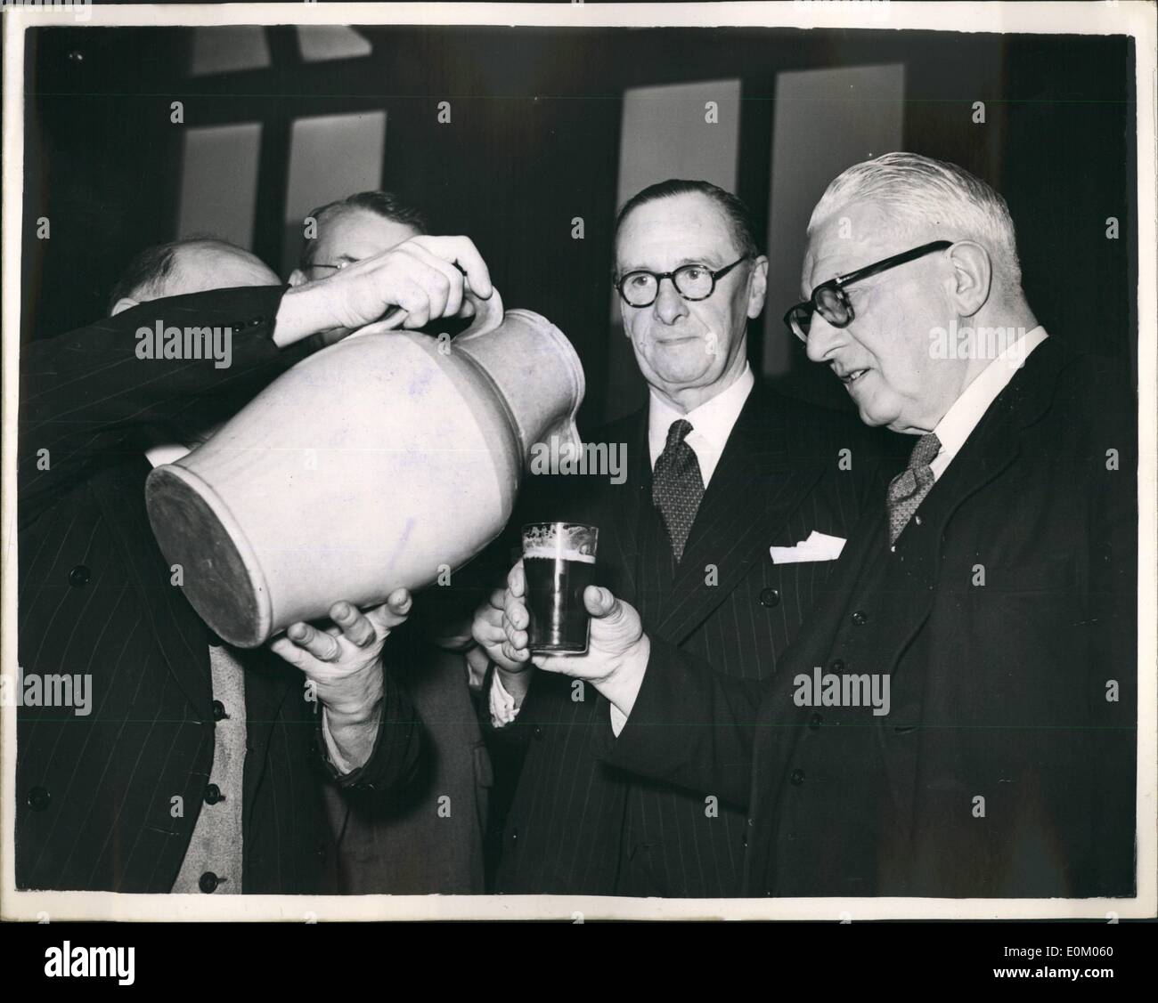 Feb. 02, 1953 - ''Cake and Ale'' ceremony at Stationer's Hall traditional distribution.: The three hundred and forty one year old ceremony of Cake and Ale Distribution at Stationer's Hall, was carried out again today - Ash Wednesday.. Hundreds of Liverymen of the Stationer's Company and the Newspaper Makers' Company filed into the hall to receive the traditional ale and cake. Photo shows Mr. J.E. nevill and Hall Keeper distributes ale to Mr. T.C. Danks a Liveryman watched by (Centre) Major T.E. Adiard who is also a Liveryman - during the ceremony today. Stock Photo