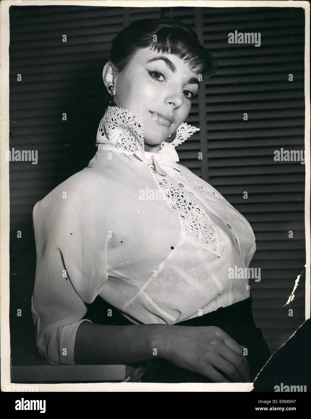 Jan. 01, 1953 - London show of spring Blouses. starlet Joan Collins, took time off the set of ''Turn the key sorority'', to model this Sybille et cie summer creation in check Georgette and epicure lace - from the Sybille at cie spring collection of blouses in Mayfair today. Feature of the blouses is an attractive stand - up collar. Stock Photo