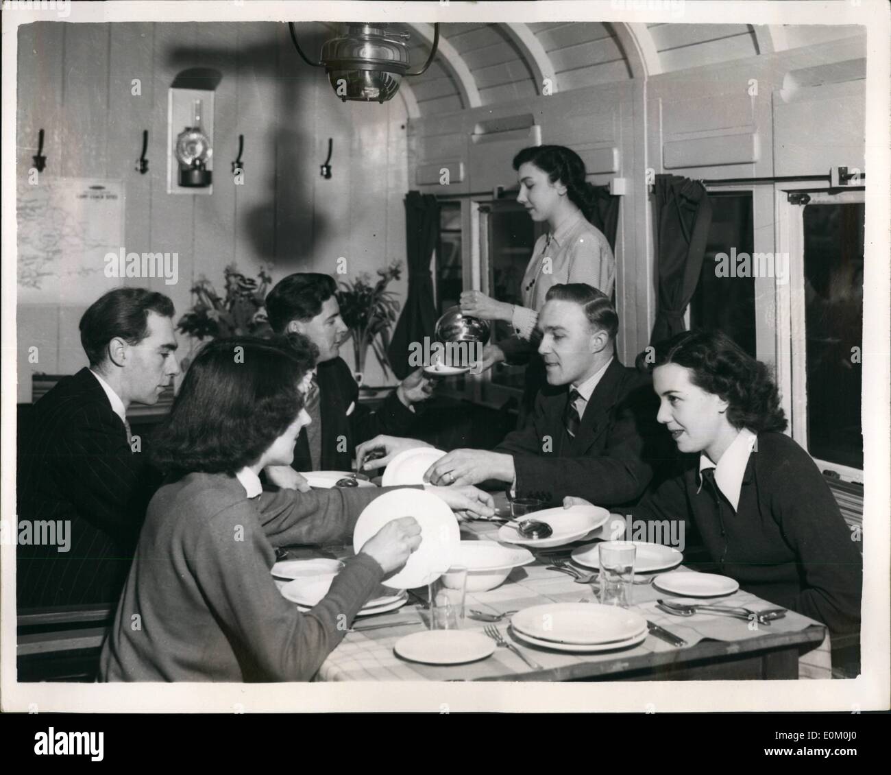 Jan. 01, 1953 - Rail camp coaches on show.: A Camp Coach, British Railways facility for luxury camping, is being exhibited to the public at Paddington. This pre-war form of holiday was re-introduced by Britain Railways last year, and, for the coming season, on the Western Region alone, will cover no less than 30 beauty spots. The coach is designed to provide sleeping accomodation for eight persons. Photo shows view of the dining room of the Camp Coach - seen at Paddington today. Stock Photo