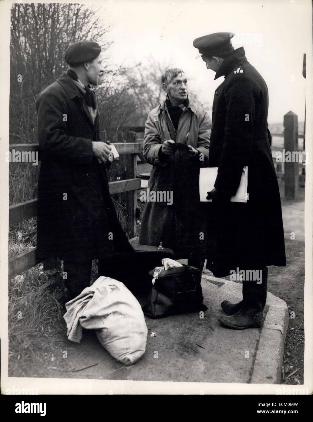 Feb. 04, 1953 - Stopping Possible Looting at Canvey .. Police Stop and Search Pedestrians: Picture shows: The Scene as police and officials stop - search and request identity papers from a pedestrian leaving Canvey Island this afternoon. Stock Photo