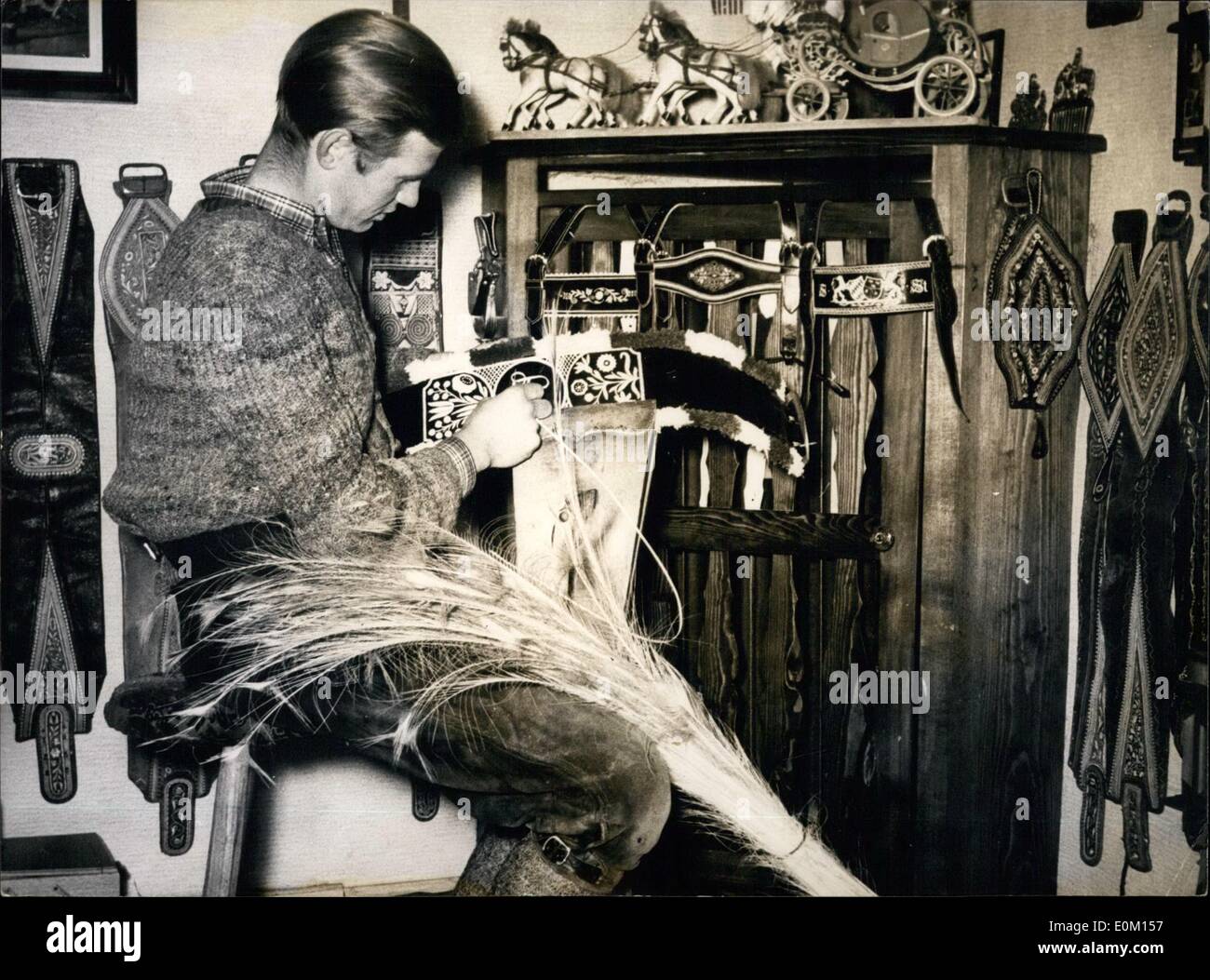 Mar. 03, 1953 - Embroidering with peacock-feathers - - is a trade which already died out. It had, however, its flowering-time about 100 years ago during the time of Andreas Hofer. The harness-maker Karl Stecker of Gmund on the Tegernsee Lake brought this trade to new life. The feathers of the peacock which are about 70 to 80 centimetres long are split and artistical embroideries are made with innumerable stitches on belts, shoes and braces Stock Photo