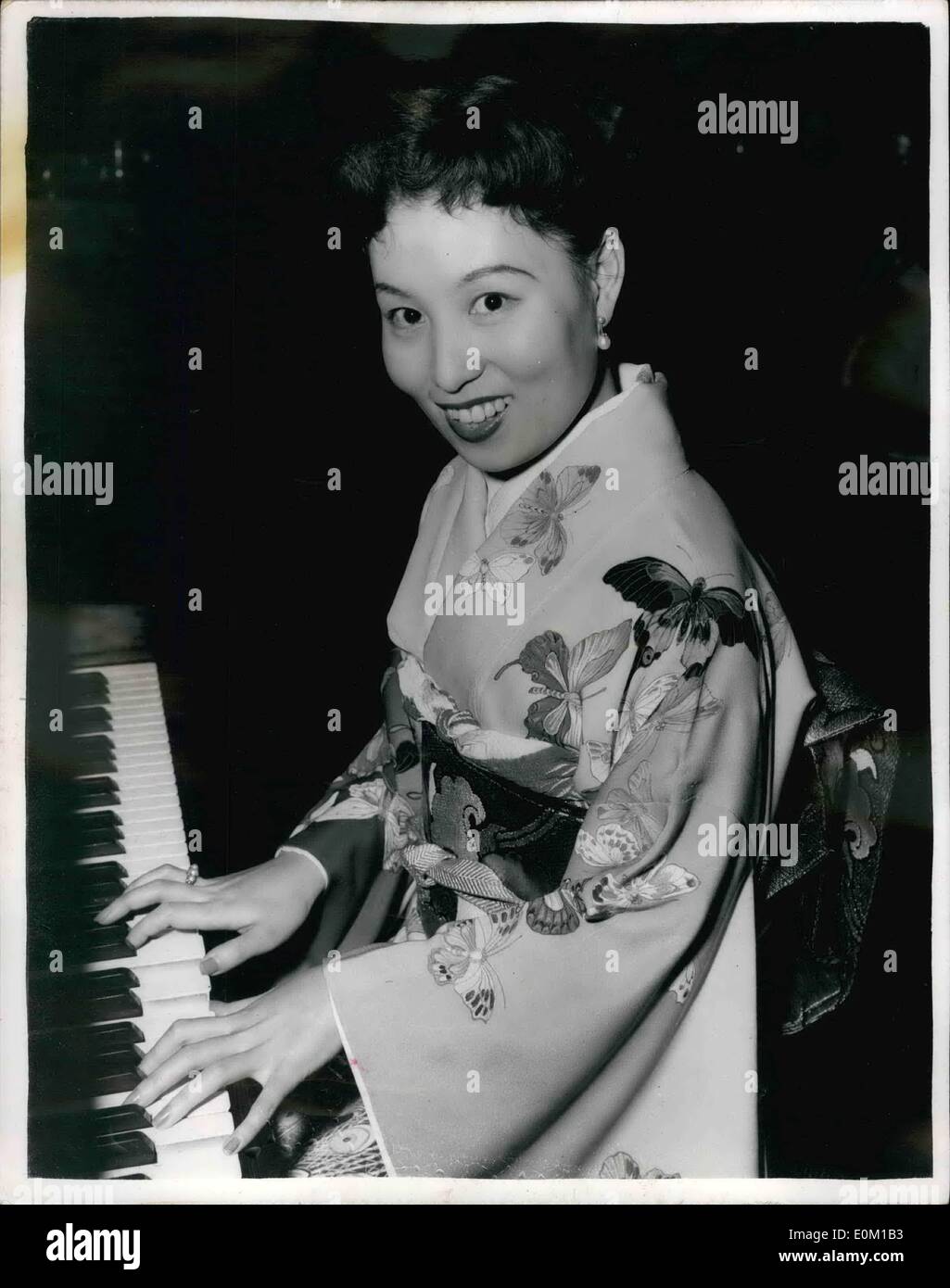 Mar. 03, 1953 - A Japanese Butterfly Makes B.B.C. Recording For Japanese Service: A madam Butterfly who really is Japanese has arrived in London. She is Michiko Sunahara from Tokio. She has been singing the role of Cho-Cho-San in Madam Butterfly for the past 18 months at the Opera Comique in Paris. Miss sunshare, at 28, one of Japan's leading sopranos, sings Madam Butterfly in Japanese and speaks little English. But her French is perfect. This evening she made a B.B.C. recording for the Japanese service. Photo shows Miss Sunahara pictured during her recording this evening. Stock Photo