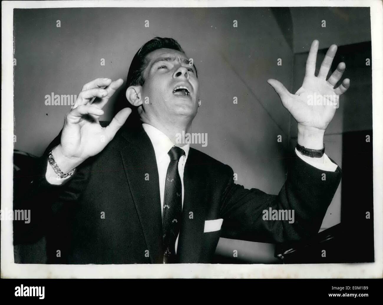 Mar. 03, 1953 - Johnnie ''Prince Of Wails'' Ray In London Press Reception Prince Of Wales Theatre: Johnnie Ray the American singer who has been given the name of ''Prince of Wails'' - among many others - arrived in London this afternoon for his London Palladium appearance next week. Photo Shows Johnnie Ray.......Sings.....during the Press Reception at the Prince of Wales Theatre - this afternoon. Stock Photo