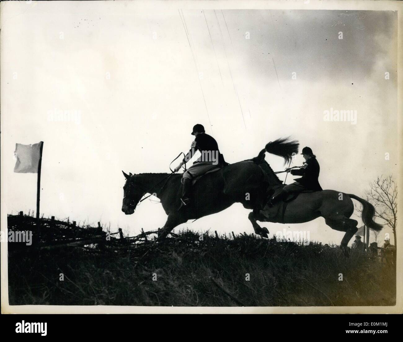 Mar. 03, 1953 - Hunter Trials At The Old Berkley Hunt: Hunter trials held by the Old Berkley Hunt at Russell Farm, Wendover, Buckinghamshire, took place yesterday. Photo Shows Sabre and Miss B. Packer are all but over the jump, followed closely by Rennie, ridden by Mrs. P. Warren. The Women were taking part in an open air class in the hunter trials. Stock Photo