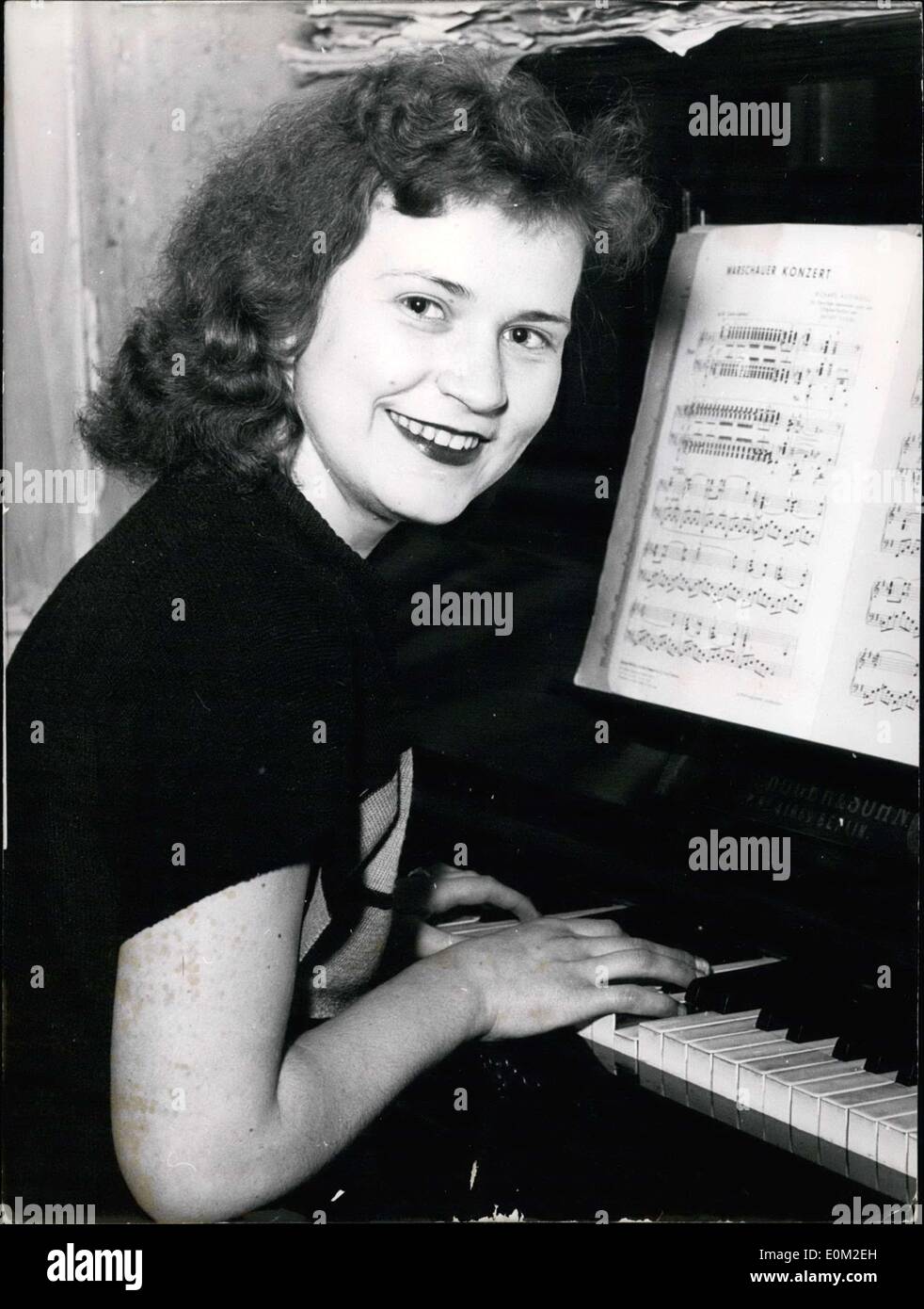Mar. 12, 1953 - Pictured is 16 year old Berlin pianist Christa Schwarz, who answered a newspaper ad from 71 year old singer Carl Neumann asking for a piano player. Neumann was discovered and trained by American soldiers three years ago. The 16 year old had only answered the newspaper ad out of fun, but now she is on her way with Carl Neumann for a tour through America. Stock Photo