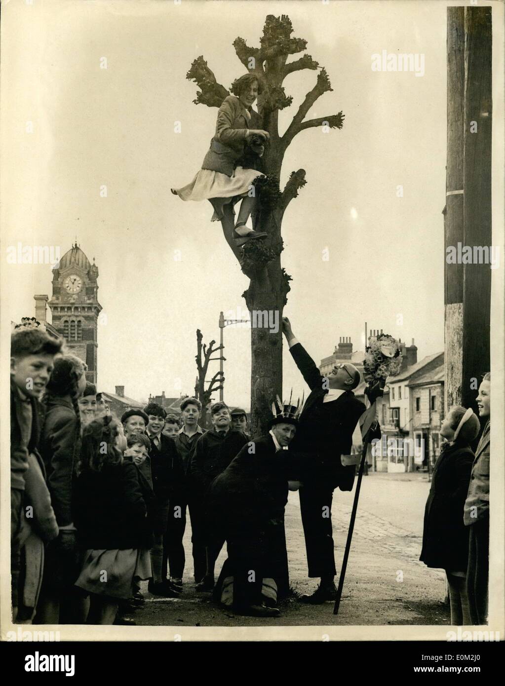 Apr. 04, 1953 - Hocktide Ceremony at Hungerford. The ancient Traditional festival at hocktide, was held today at Hungerford, Berks. In accordance with custom, The Tuttimen went through the town with their flower decorated staves, to collect their ''Dues'' a kiss or a penny from the women of the town. Keystone Photo Shows: Mr. R.A. Bartholomew, a tuttiman, carrying his stave, being assisted by Mr. G.T. Scarlett up a tree to get his ''due'' - a kiss or a penny, from Miss Gillian Fraser, at Hungerford today. Stock Photo