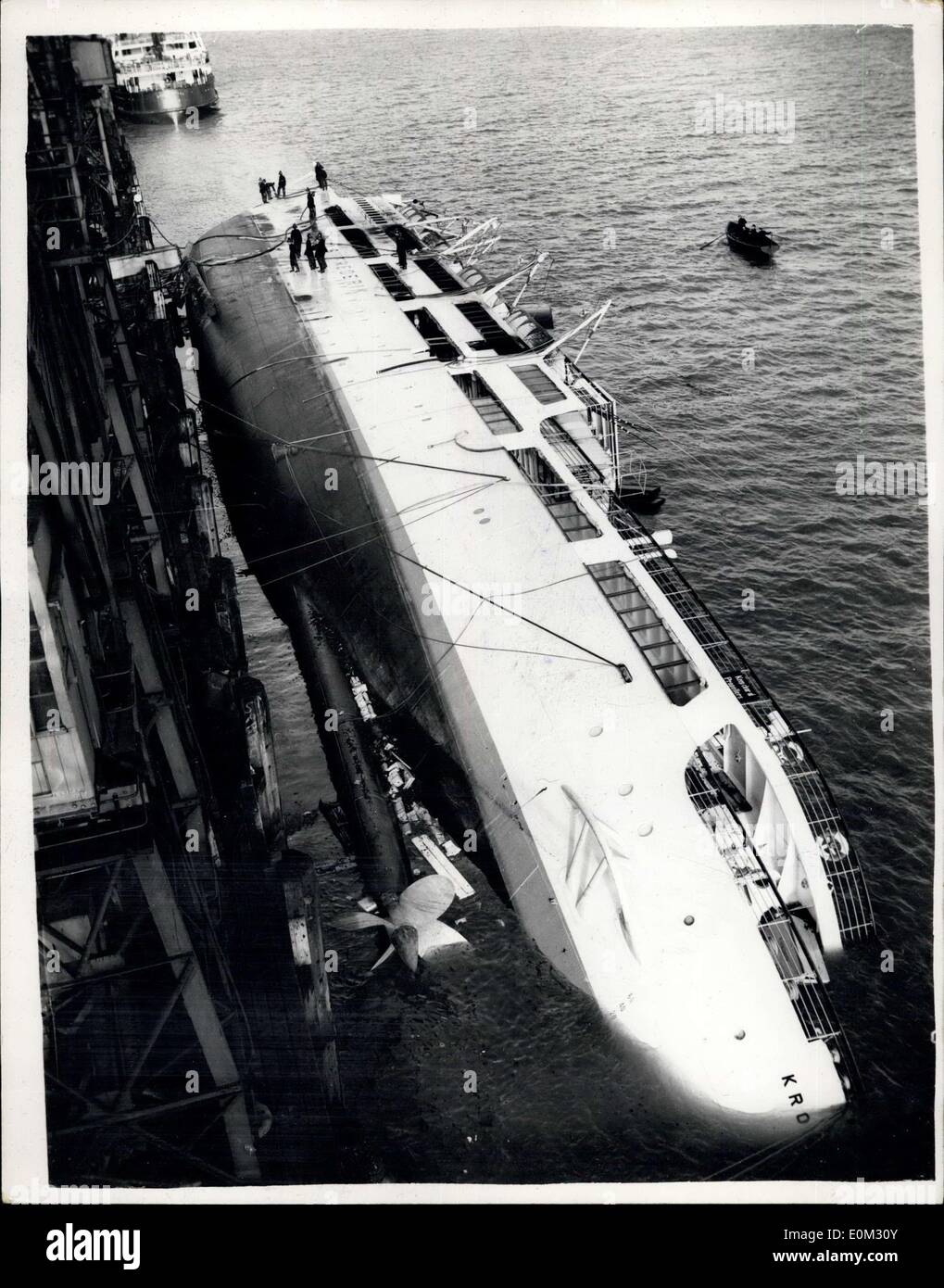Apr. 20, 1953 - Danish Vesel ''Kronprins Frederik'' Capsizes after Burning All Night Long. The Danish passenger ship ''Kronprins Frederik'' capsized this morning in her berth at Harwick after fire hade waged in her all night long. Three firemen and two members of the crew were injured. Keystone Photo Shows: View of the ''Kronprins Frederik'' still smouldering as she lies on her side in her berth at Harwick this morning. Stock Photo