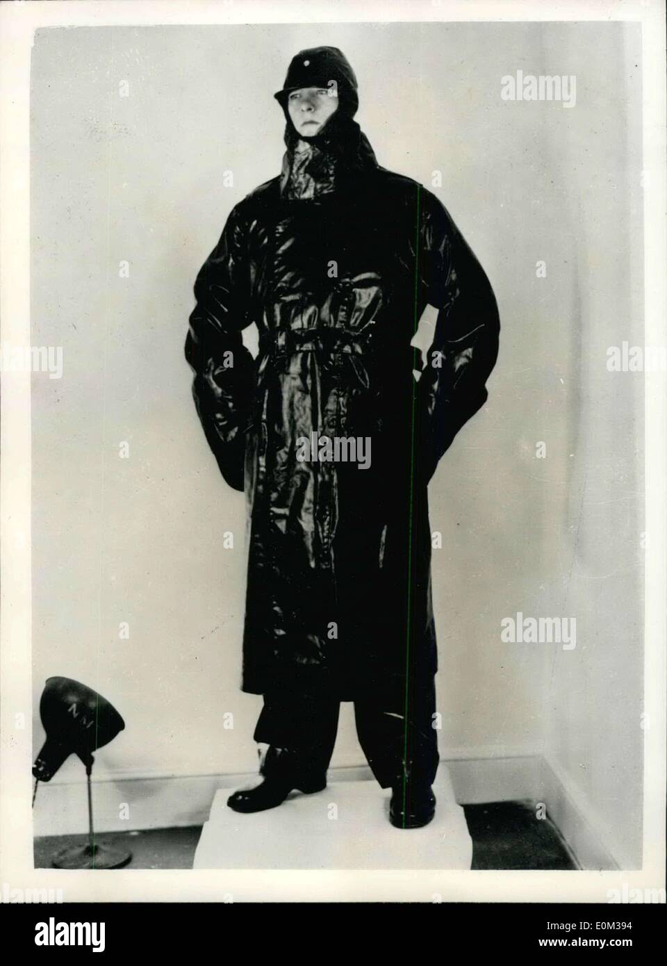 May 04, 1953 - New Impregnated Waterproof Garment For Issue To Personnel Of The Royal Navy: New types of fabric impregnated with Polyvinyl chloride are now being introduced into Royal Navy service to replace oil skin garments, as stocks of the latter become exhausted. Photo shows The new long coat and trousers and the hood which replace the sou'wester of the impregnated fabric. Stock Photo