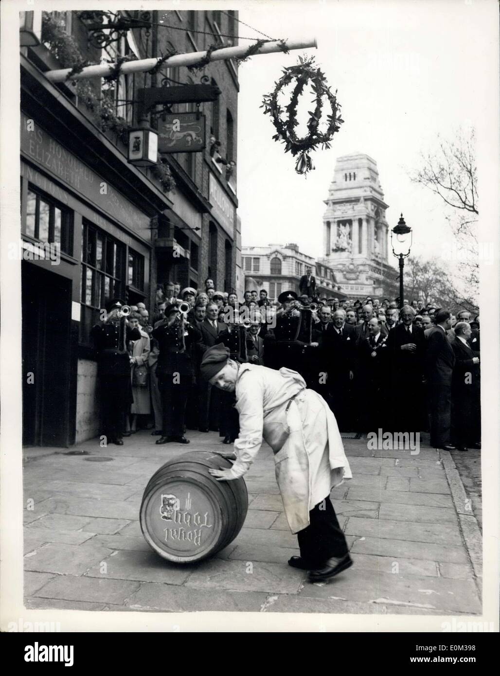 May 04, 1953 - Annual ale gonning ceremony.: In the days of Queen Elizabeth I, no tavern keper or brewer was permitted to sell ale to the public before it had been sampled by an official alconner. When a new brew was made a pol, or alestake, was placed outside the premiers as a sign that the services of the ale-conner were required, and heavy fines were exacted fro failure to do so. The ancient Ale-Conning ceremony, was held today at the Tiger Inn, Tower Hill. Photo shows a dryman rolls in a barrel of ale at today's ceremony at the Tiger Inn, Tower Hill. Stock Photo