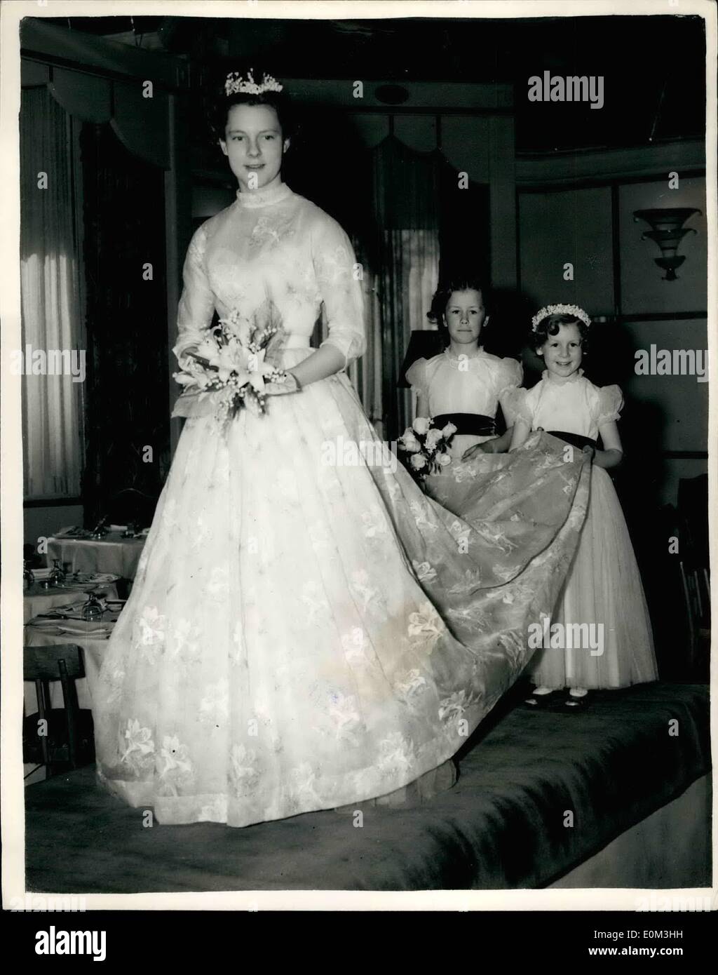 May 05, 1953 - Final Dress Rehearsal for the Berkeley debutante dress show: wedding gonna by Dior: A final dress reheard was held this morning at the Berkley restaurant - for this afternoon's Berkeley Debutante Dress show to be held in aid of the N.s.p.c.g.- and in which debutantes are displaying styles by the famous Christian Dior. Keystone photo shows lady Roee Blithe were a white Organza wedding gown, gold embroidery and lilies. The bridal attendants, whose dresses are not by Dior - are ( left) Wish Mary Anne Parker-Bonnee (7) and winsSarah Greenly aged 6. Stock Photo