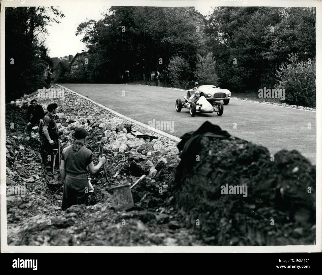 May 05, 1953 - Motor Racing Practice At Crystal Palace: Arrangements are going a head at the Crystal Palace motor racing track preparation for the first meeting on Whit Monday, May 25th, which is being organised by the British Automobiles Racing Club. The construction of the new link section of the track to exclude the inner loop is now completed. Several racing cars were at speed today, testing the new circuit. Photo Shows Racing cars seen at speed on the new circuit, as workmen pauz in their test of working on the side of the track. Stock Photo