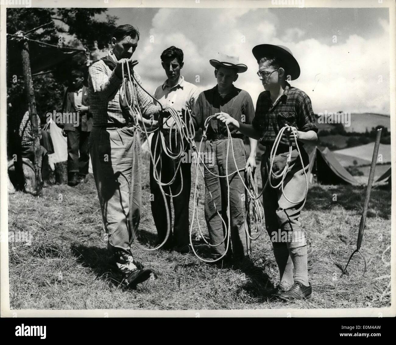 Jul. 24, 1953 - 24-7-53 The young cowboys of Dartmoor. Lasso lessons. Ex-South American cowpuncher Ross Salmon is holding a two weeks course for would-be cowboys on his School for Cowboysat Longdown, near Exster, where he hopes to start a cattle range. He plans to rear cattle in real ranching style on 25,000 of Dartmoor's lonely acres in an effort to put to use some of the wastelands of Britain. To do it he is teaching the boys to ride cowboy style and to do everything that a real Western Cowboy has to do which is rather different to the Cowboys of the Sereen Stock Photo