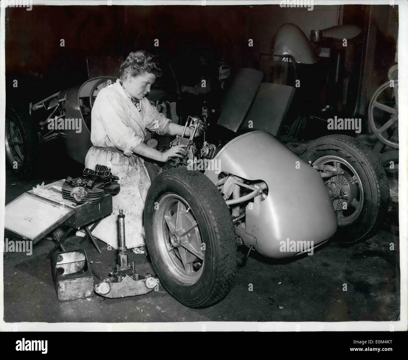 Jul. 07, 1953 - Britain's only girl racing car manufacturer; 27 year old Daphine Arnott, Britain's only girl racing car manufacturer, builds her car bodies with fiber glass. Her first glass car raced at Silverstone last Saturday. Amid the crackle of tuning engines in her Edgware, Middlesex, ''Shop'' yesterday she said she was going to fit all ten of ther squat racers wit h20 lb fiber glass bodies. They're a third of the weight of aluminum and a dent can be pressed out gently with the hand. Holes are easy to repair with a patch of the right size and a pot of glue Stock Photo