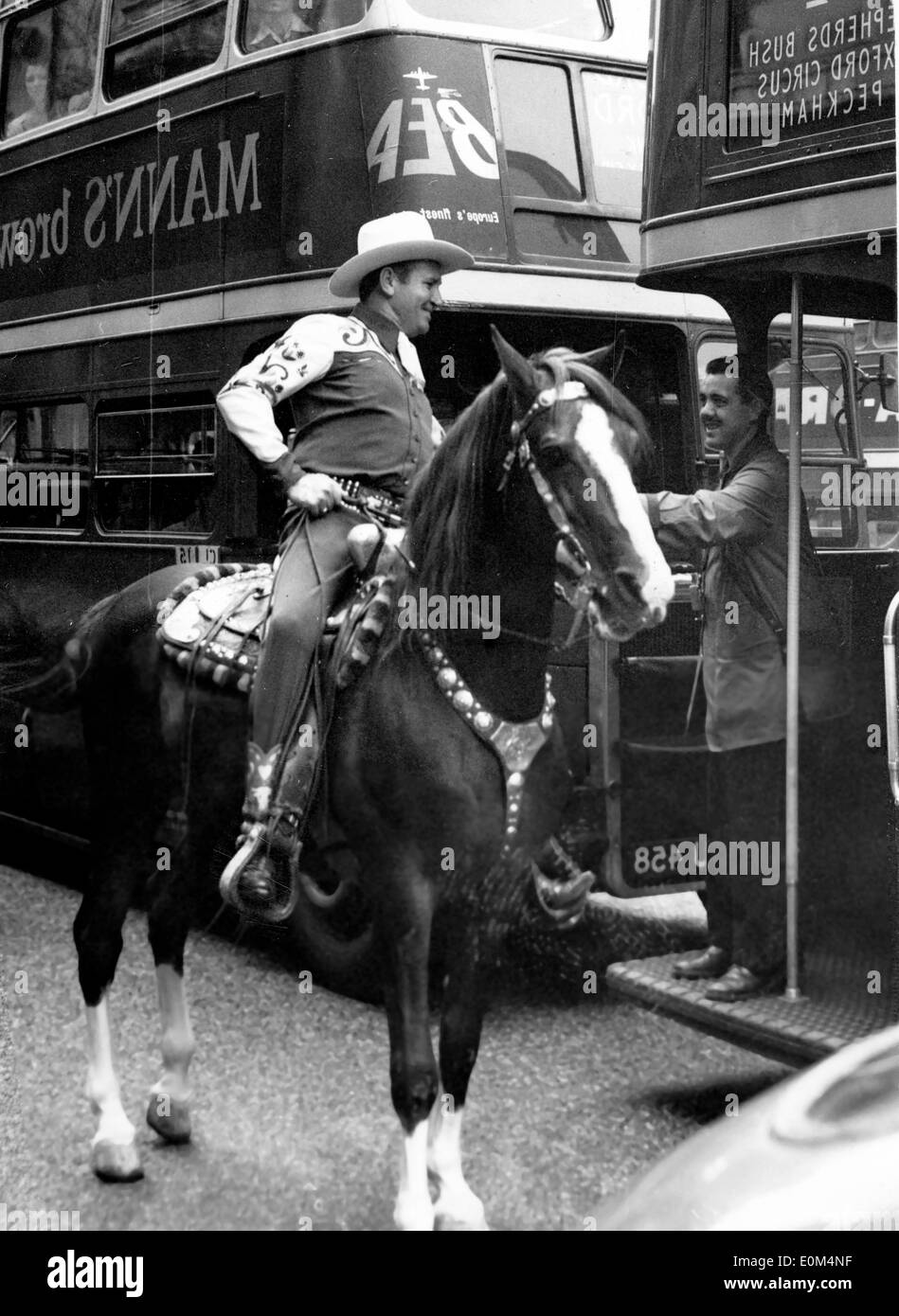 A bus conductor petting Gene Autry's horse on Oxford Street Stock Photo