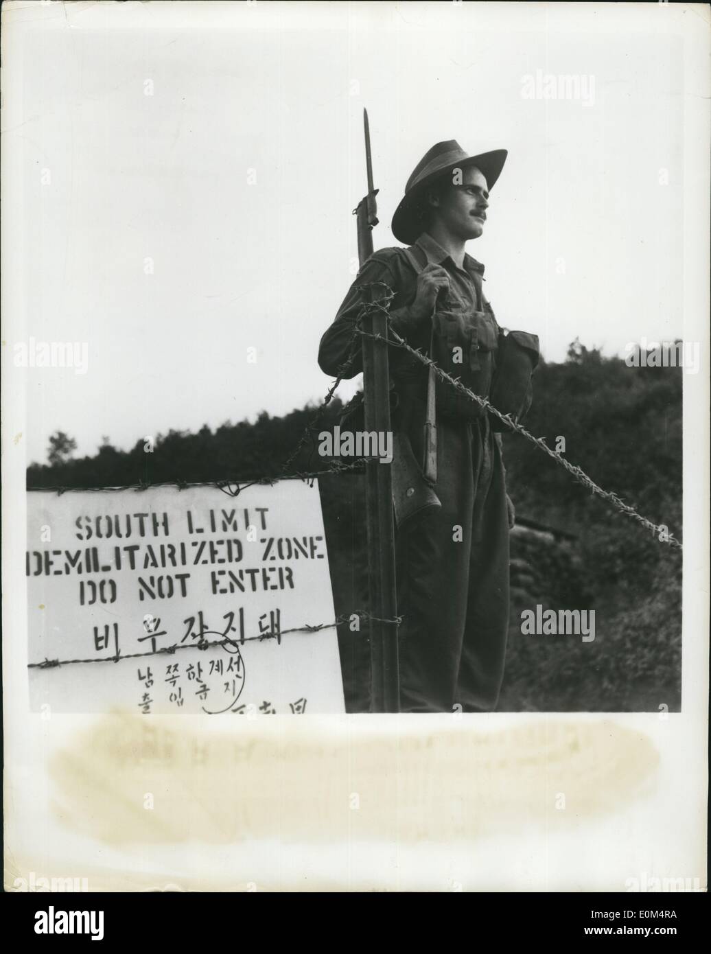Aug. 08, 1953 - Guarding The Truce In Korea: While negotiations are under way for a lasting peace in Korea, war-weary soldiers stand guard along the 2 1/2 mile demilitarized zone to watch for truce violations. Photo shows. Private Terry Mahoney of the 3rd Batallion, Royal Australian Regiment, charged with keeping sightseers and other unauthorized people out of the armistice demilitarized zone stands guard on a road crossing its southern limits. Soldiers from countries of the British Commonwealth have fought by the side of Americans since the first months of the war in Korea. Stock Photo
