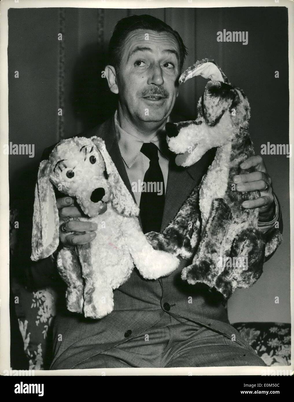 Jul. 07, 1953 - Walt Disney introduces his newest characters ''The Lady'' and ''The Tramp''. A couple of Dogs.: World famous Hollywood cartoonist Walt Disney was to be seen in London today introducing his two new characters - two dogs are called ''The lady and one called ''The Tramp''. The appear in his new cartoon film of the same name (The Lady and The Tramp) which is still in production. Walt Disney explained that a ''Lady'' is a pedigree dog of Coker Spaniel carity - and ''The Tramp'' is a mixed breed - full of fun and collar free Stock Photo