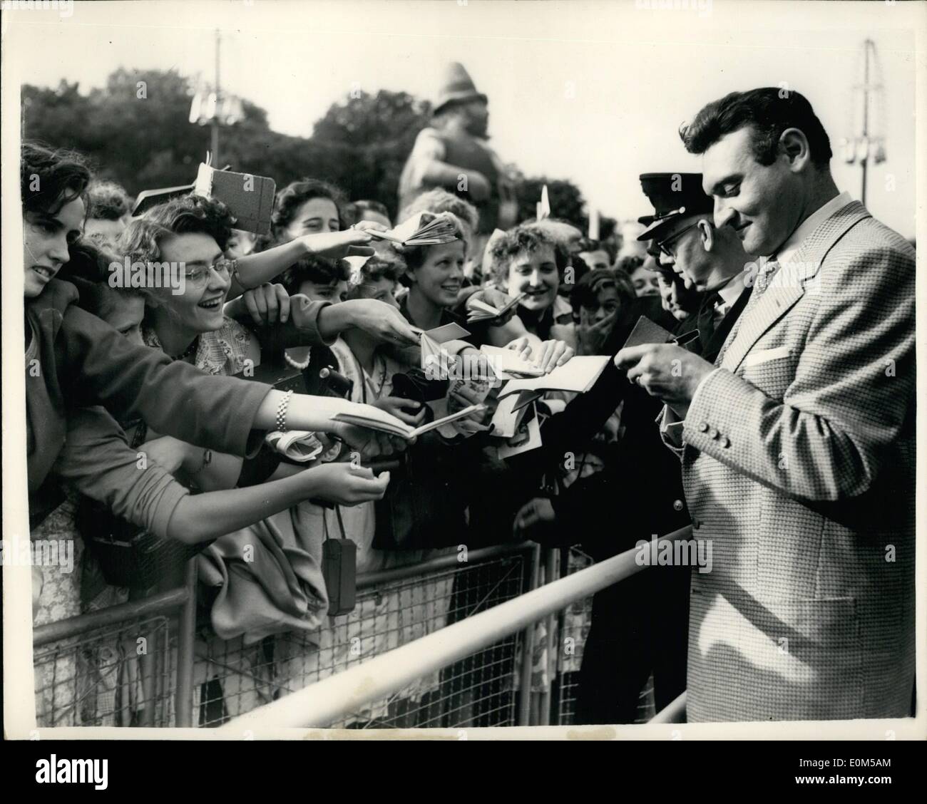 Aug. 08, 1953 - Britain's First Mass Fan Club Party To Welcome Back Frankie Laine: Members of the British Frankie Laine Fan Club, which has a membership of 25,000, gave a ''welcome back'' part to the famous American singer, at the Festival Gardens, on the South Bank, this evening. Special police were called in to control the crowds. Photo shows Some of the fans push their way to the front to get Frankie Laine's autograph. Stock Photo