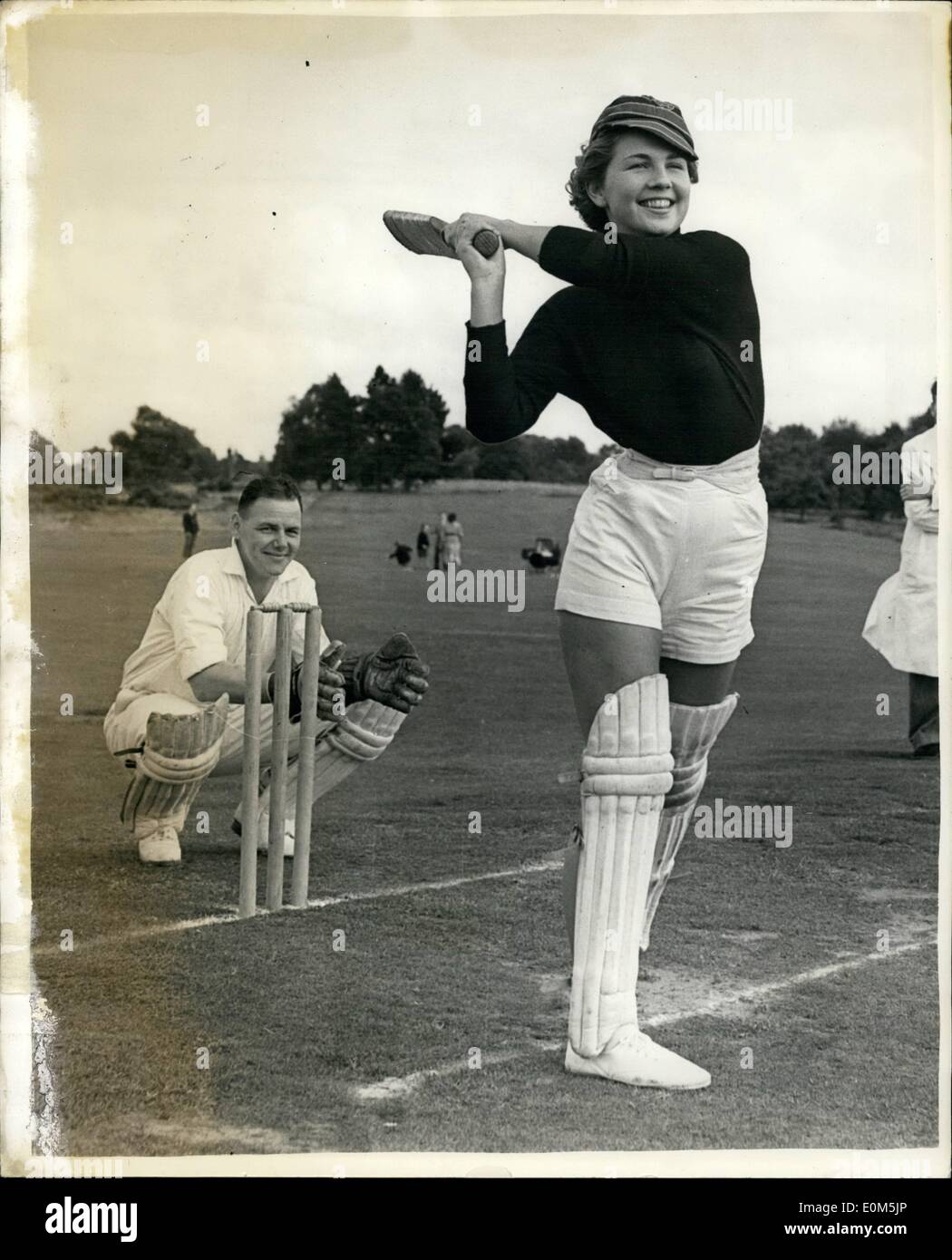 Jul. 07, 1953 - Village team versus the Fashion Models. Diana Ferry hits out at a ball - when she turned out for the team of Lucy Claytons Fashion Models in their unique cricket match with the local Puttenham and Wanborough Cricket XI - at the village ground, Mr. Guildford, Surrey - yesterday. Stock Photo