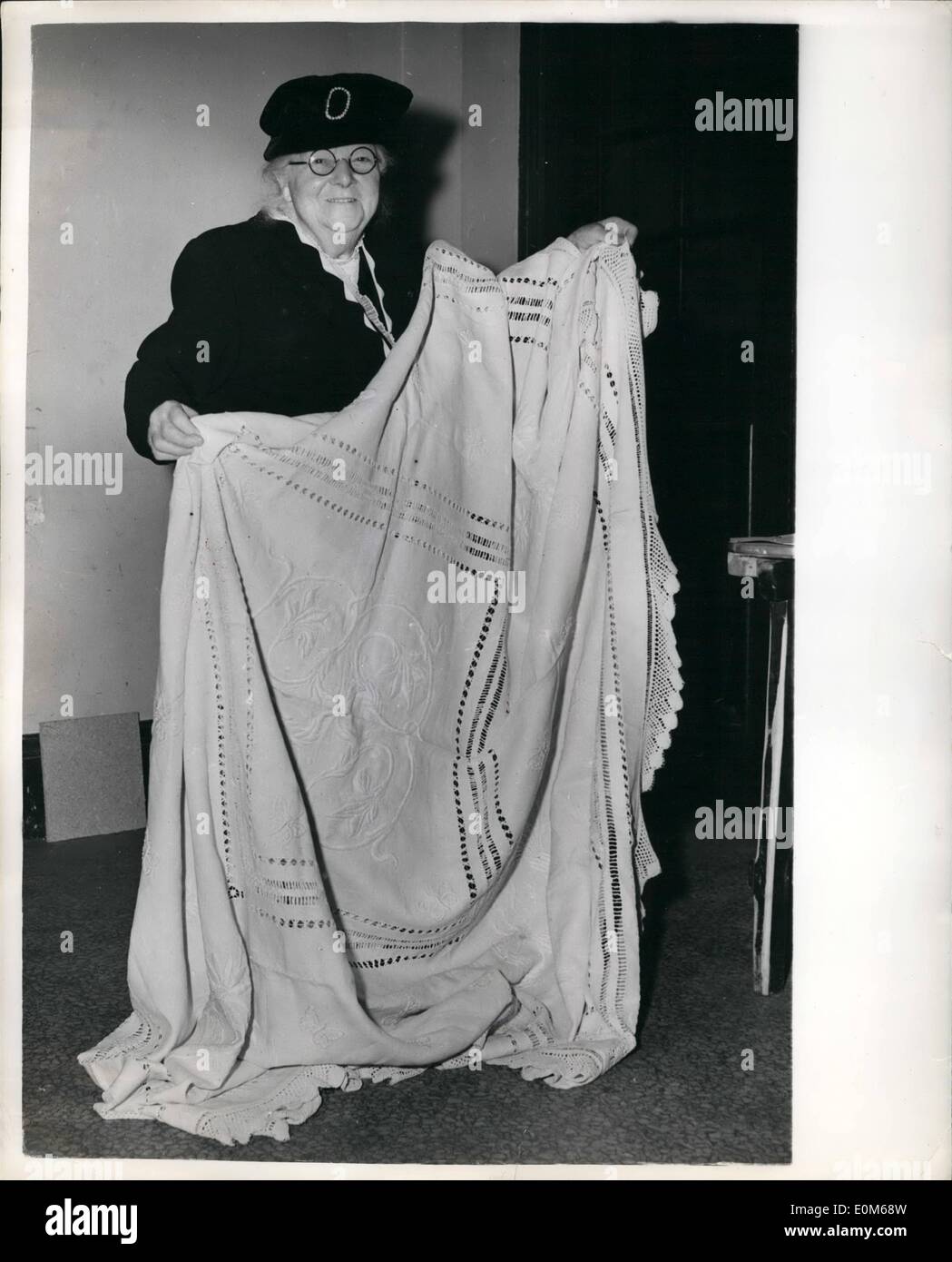Sep. 09, 1953 - National Handicrafts and hobbies Exhibition. The National Handicrafts and Hobbies Exhibition opened today at the Central Hall, Westminster. Photo Shows Miss A. Bennett, aged 83, of Kensington, seen with her exhibit at the exhibition. It is a bedspread which was started as a linen woven sheet by Miss Bennet's great-great-grandmother for her ''bottom drawer'', and each generation has added something to it. This year Miss Bennet has added 10 yards of lace-edging. Stock Photo