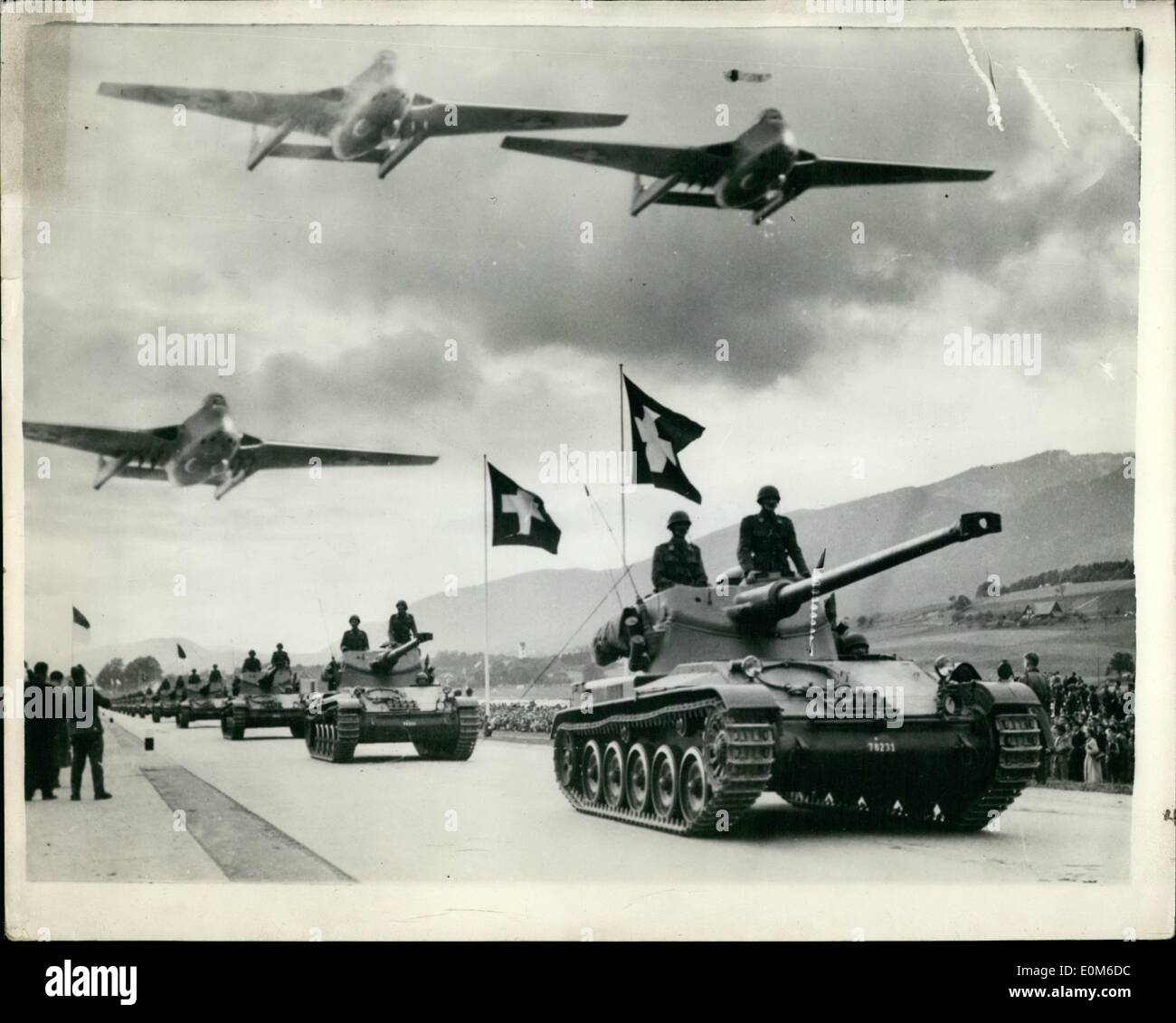 Oct. 10, 1953 - Parade Of The Swiss Army And Air Force Armoured Cars And Vampires in Review: Photo Shows The impressive scene during the big parade of the Swiss Army in the Kantonsstrasse near Scolothurn and Biesel.Tanks and armoured vehicles of the Amx type can be seen while flying overhead are Vampire aircraft which are now being produced in licence in Switzerland. Stock Photo