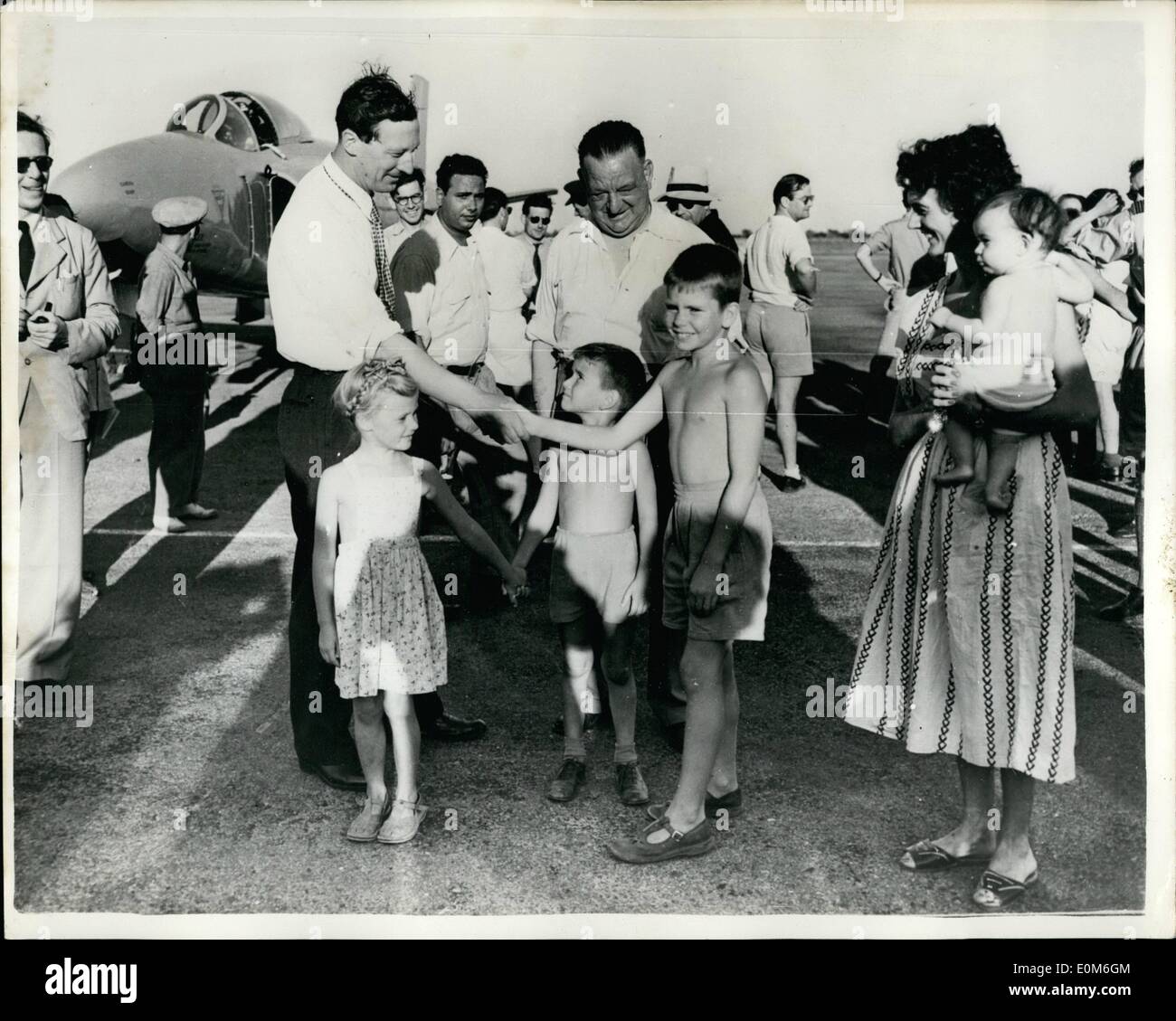 Sep. 09, 1953 - Attempt On World Air Speed Record: Picture taken in Libya, where an attempt is likely to be made this week to break the world speed record recently set up by Neville Duke. This attempt will be made by he Vickers Supermarine ''Swift'', piloted by Mike Lithgow. Photo Shows: Lithgow being greeted by young Michael Metcalfe on his arrival at the RAF station, Castel Idris. Also seen are Diane Booker and Rodger Metcalfe, with Mrs. Booker (Who is the wife of an RAF officer) Stock Photo