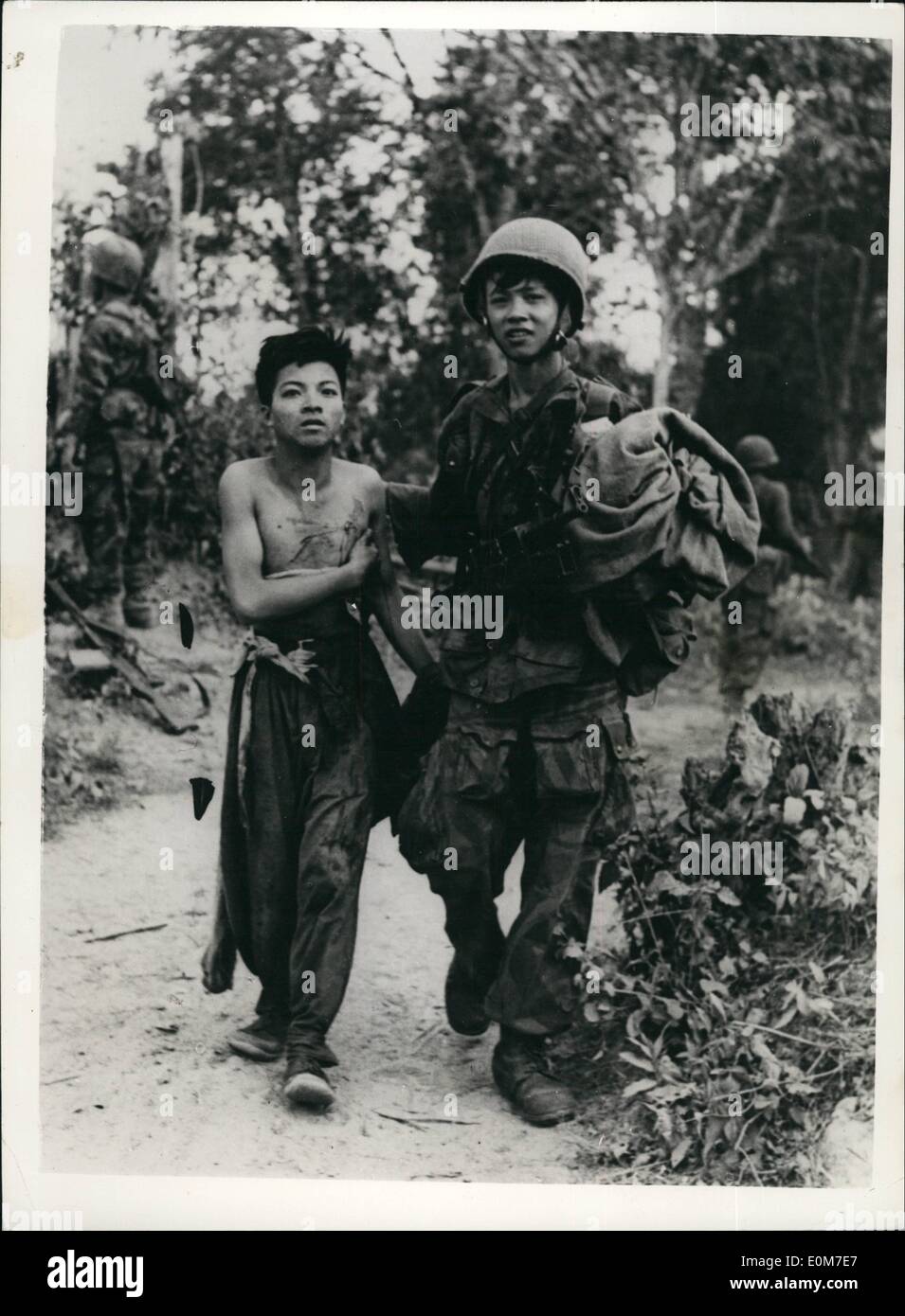 Jan. 01, 1954 - Youth captures youth. The war in Indo-China.: A young wounded Vietminh prisoner, is brought in behind the fighting line by a young Vietnam paratrooper - during an action by Vietnam paratroopers at Hine Sin, during the war in Indo-China. Stock Photo