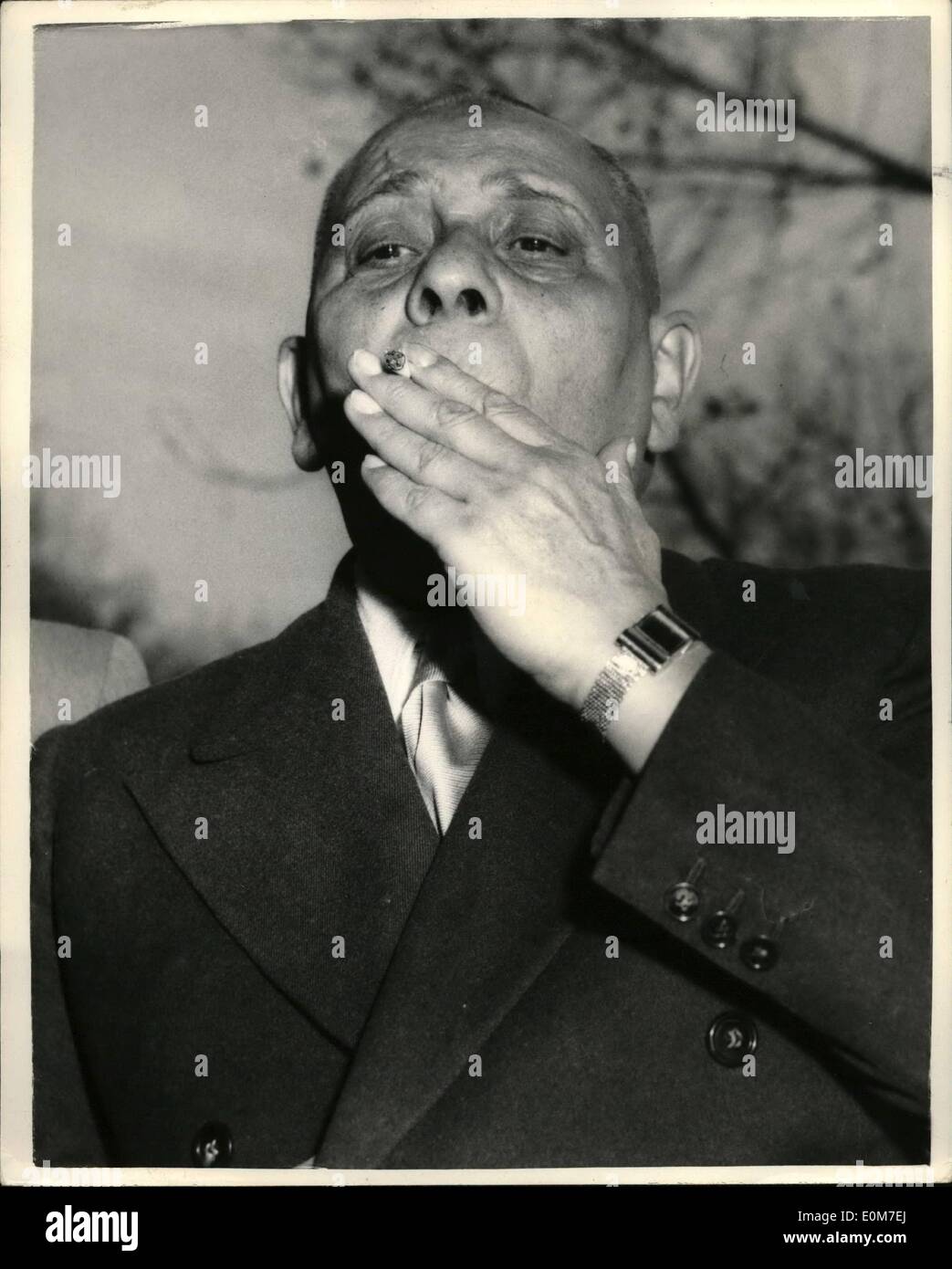 Jan. 01, 1954 - Erich Von Stroheim Holds A Press Conference Make-Shift Monocle: Erich Von Stroheim the monocled, bullying Prussian of pre-war films - who arrived in London this morning - held a press conference at the Savoy Hotel this afternoon. Photo shows Erich Von Stroheim takes a pull at his cigarette - during the conference this afternoon. Stock Photo