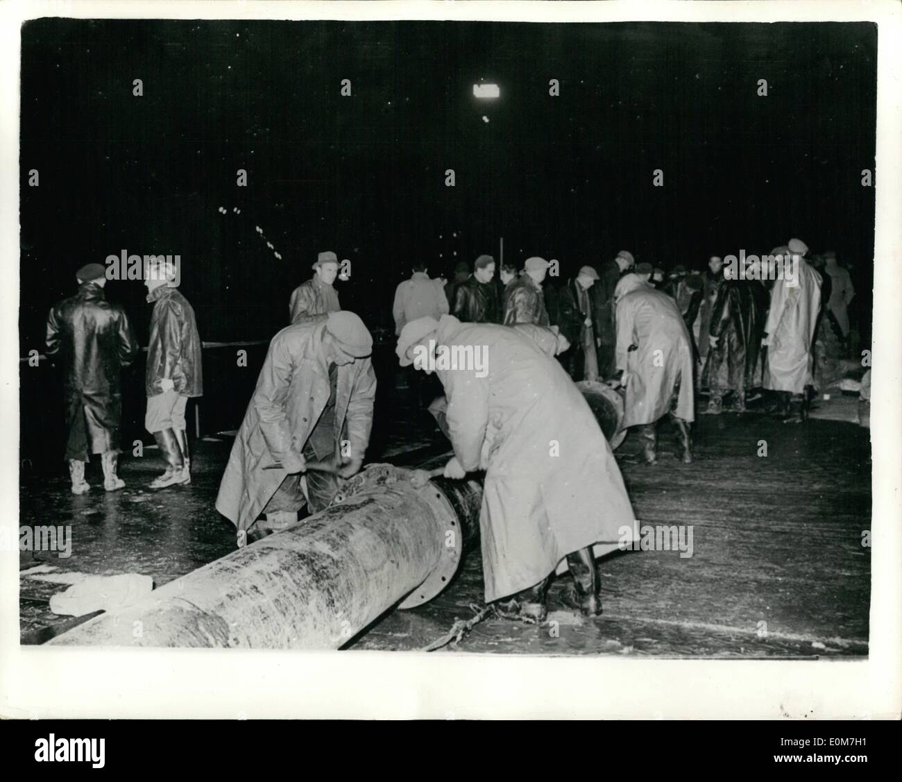 Nov. 11, 1953 - Holland closes the breeches. The final dykes are repaired. Photo shows: Work progresses far into the nigh tightening the drain pipe connections - during the placing into position of the final caissons at Ouwerkerk at the Isle of Schouwan - to complete the work which has been going on throughout the Netherlands repairing the flood walls - since the disastrous floods which wrought havoc last February. Stock Photo