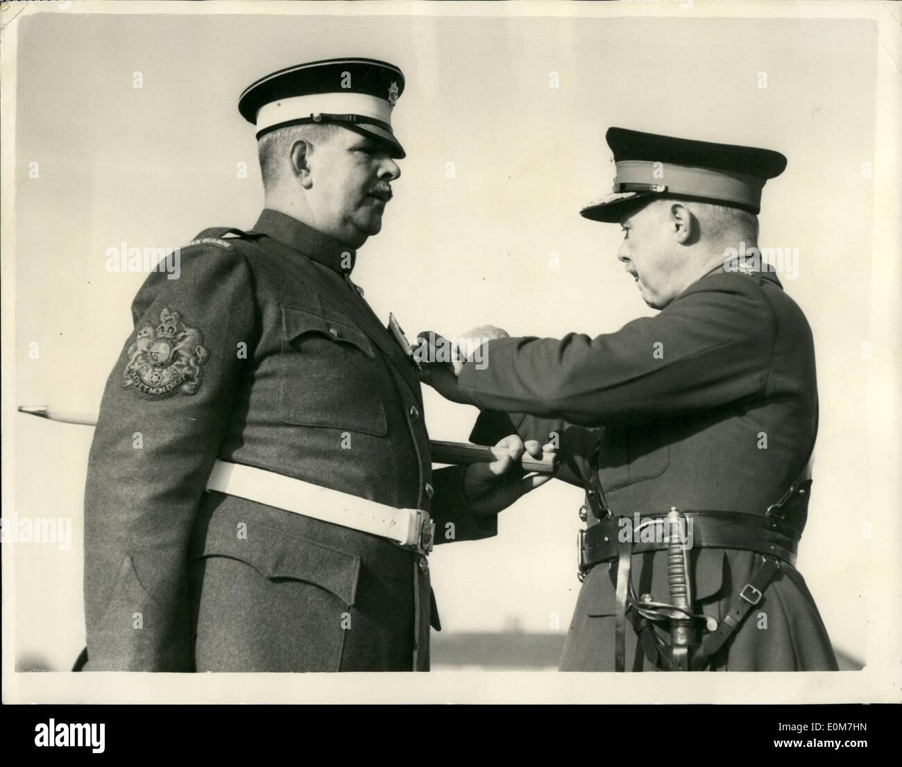 Nov. 11, 1953 - RSM Brittain Receives award: Regimental Sergeant Ronald Brittain, Coldtsrem Guards, owner of ''the loudest voice in the British Army'' today received a bar to his long Service and Goal conduct Medal. He has been in the Army 56 years. The presentation was made by Major General E.S.B. Gaffney, GOC Aldershot Wistrict at a passing out parade at Mons Officer Cadet School, Aldershot. Photo shows RSM Ronald Brittain being presented with his award by Major General E.S.B. Gaffney at Aldershot today. Stock Photo