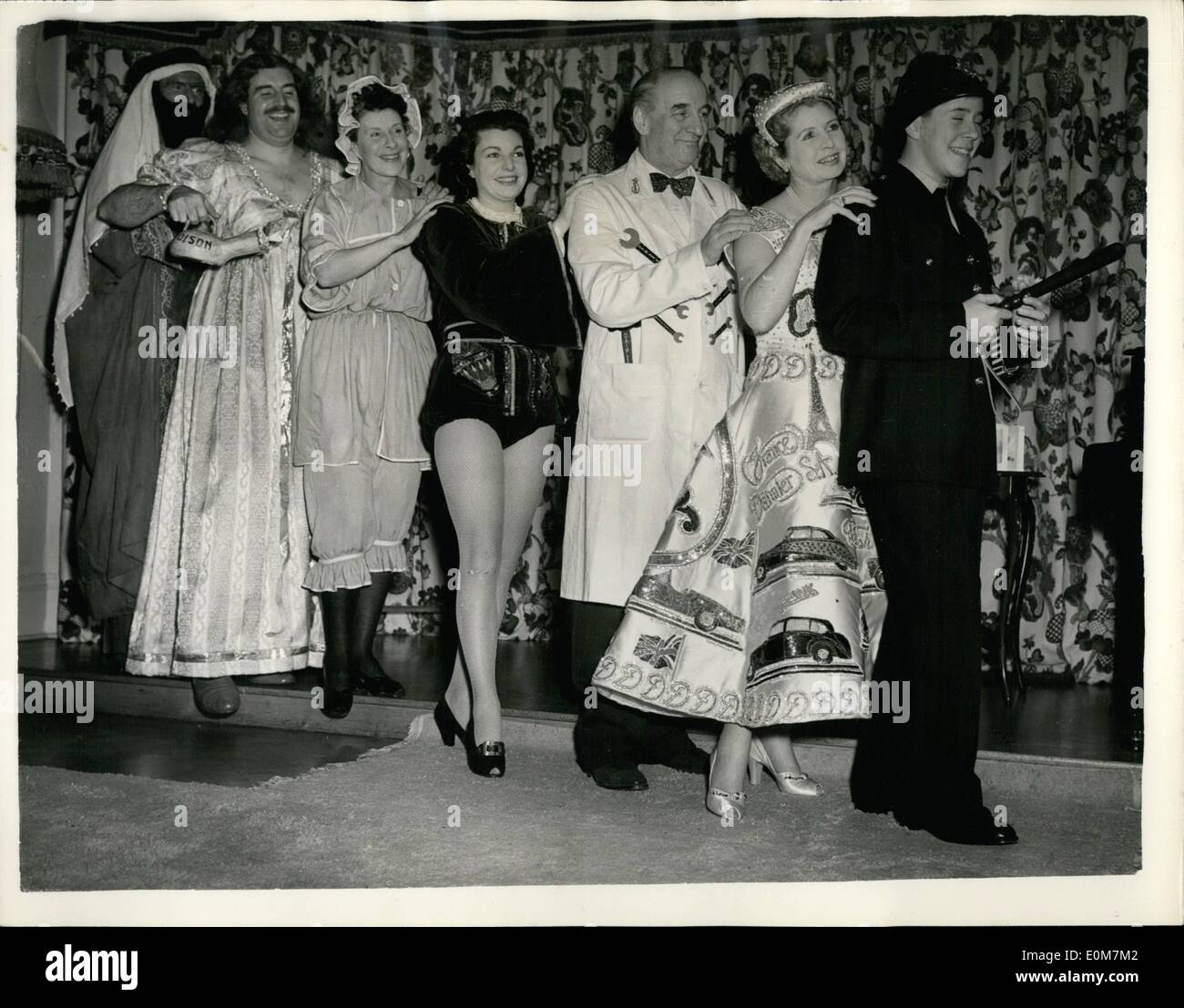 Jan. 01, 1954 - The Dockers attend New Year Ball introducing the ''Daimler'' dress.: Quite a sensation was created at the New Years Eve Fancy Dress Ball at the Poole Harbour Yacht Club by the unique dress worn by Lady Docker. The dress is white slipper satin embossed with diamante and sequins to represent every make of Daimler car. Photo shows Lance the son of Sir Bernard and Lady Docker leads the ''Conga'' followed by his mother wearing the ''Daimler Dress'' and his father as a ''Garage Hand'' and other guests at the ball. Stock Photo